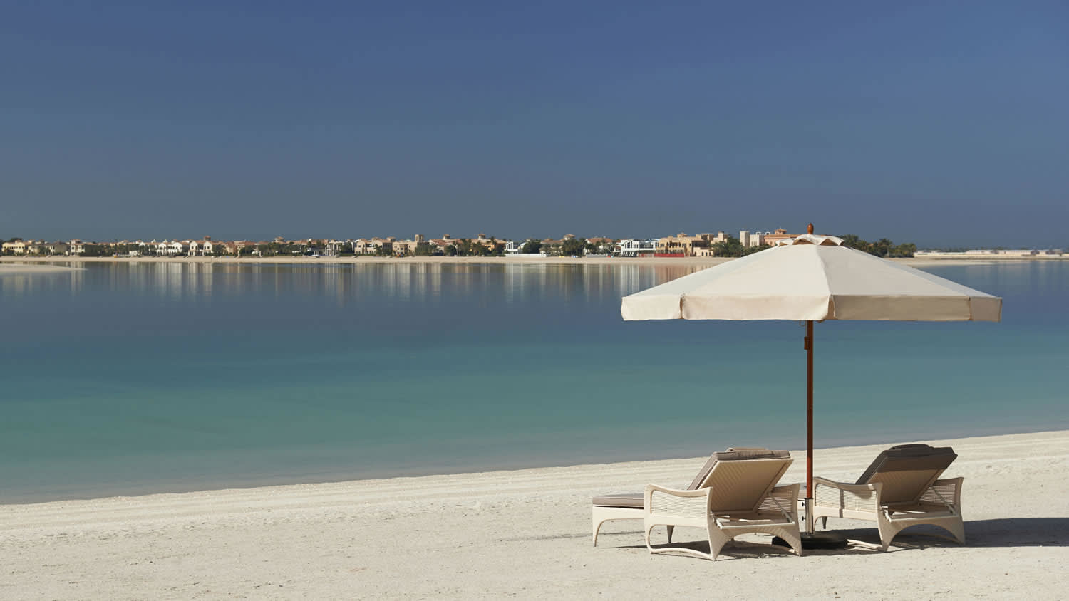 a close up of an umbrella on a beach near a body of water