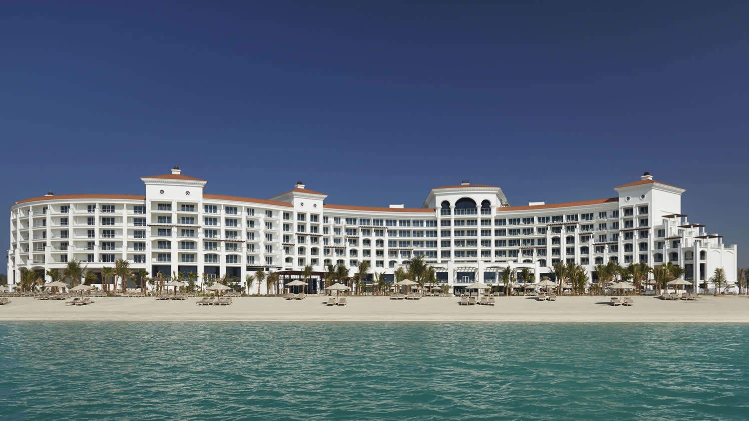 a large body of water with buildings in the background