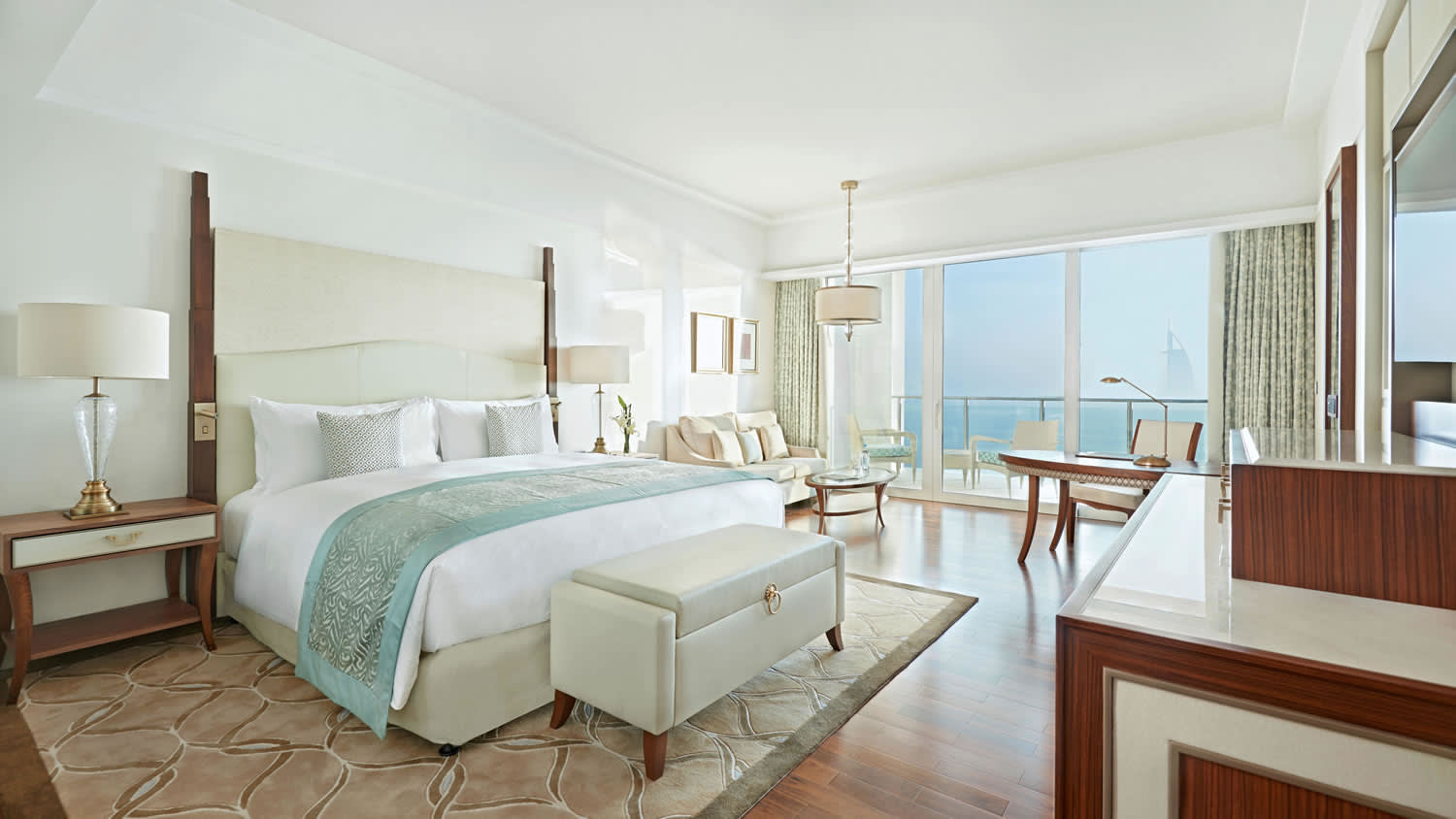 a bedroom with a bed and a chair in a room