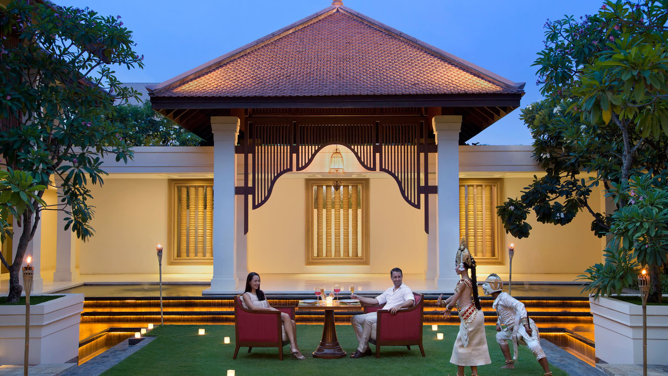 a bench in front of a house with Redwood Library and Athenaeum in the background