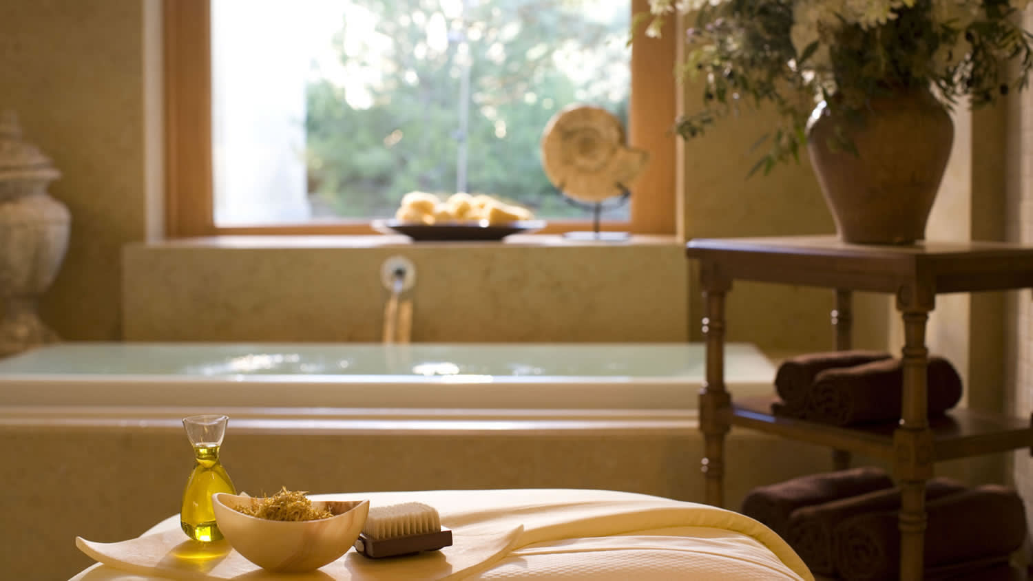 a vase of flowers on a table in front of a window