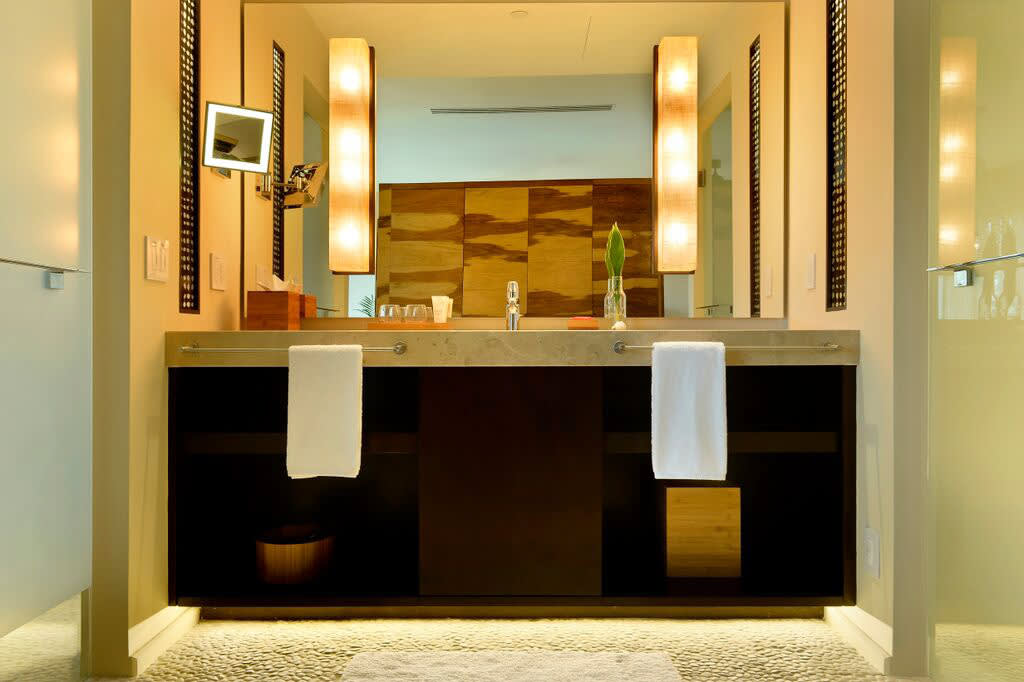 a hotel room with a sink and a mirror