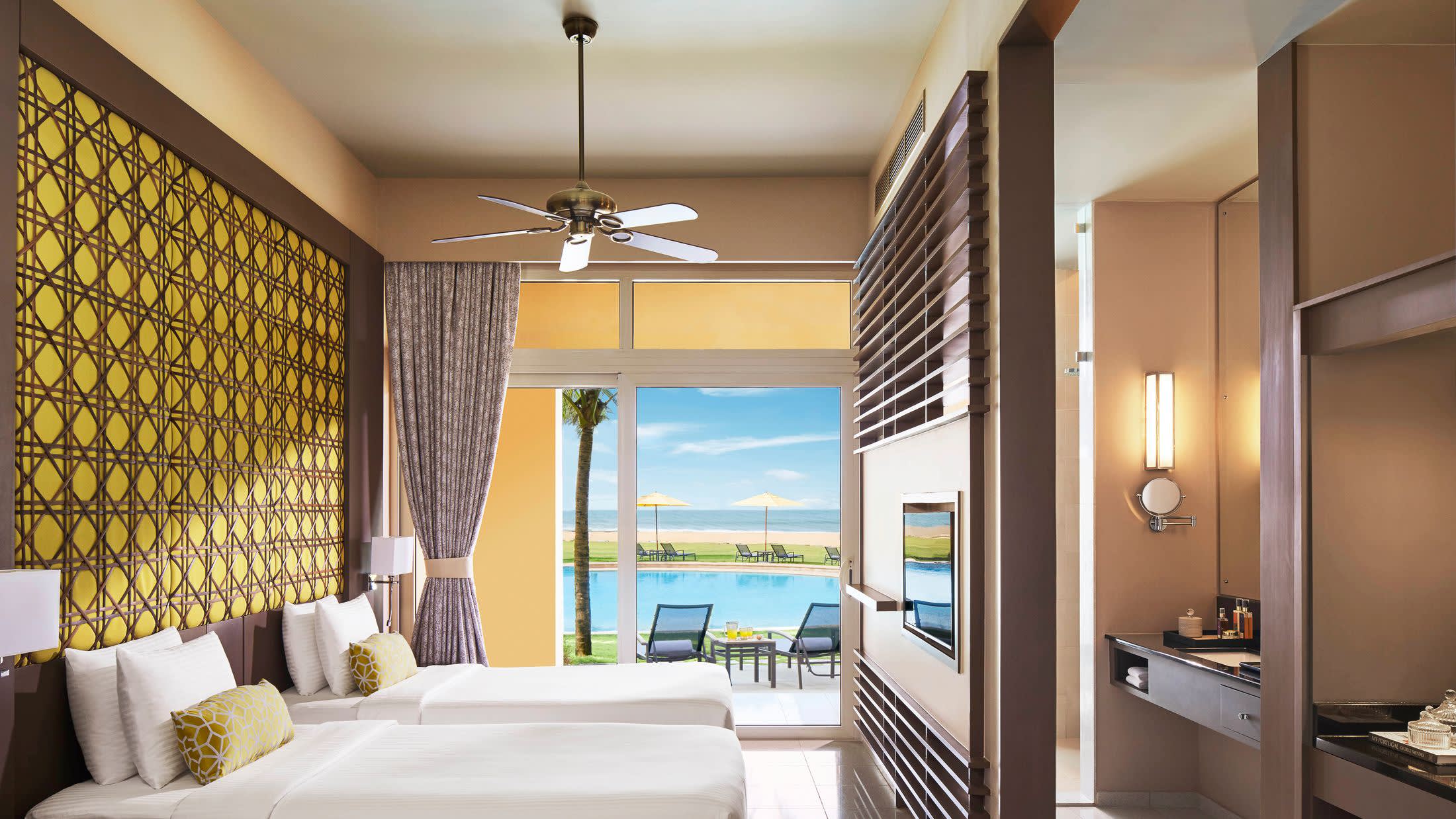 a bedroom with a bed and a mirror in a room