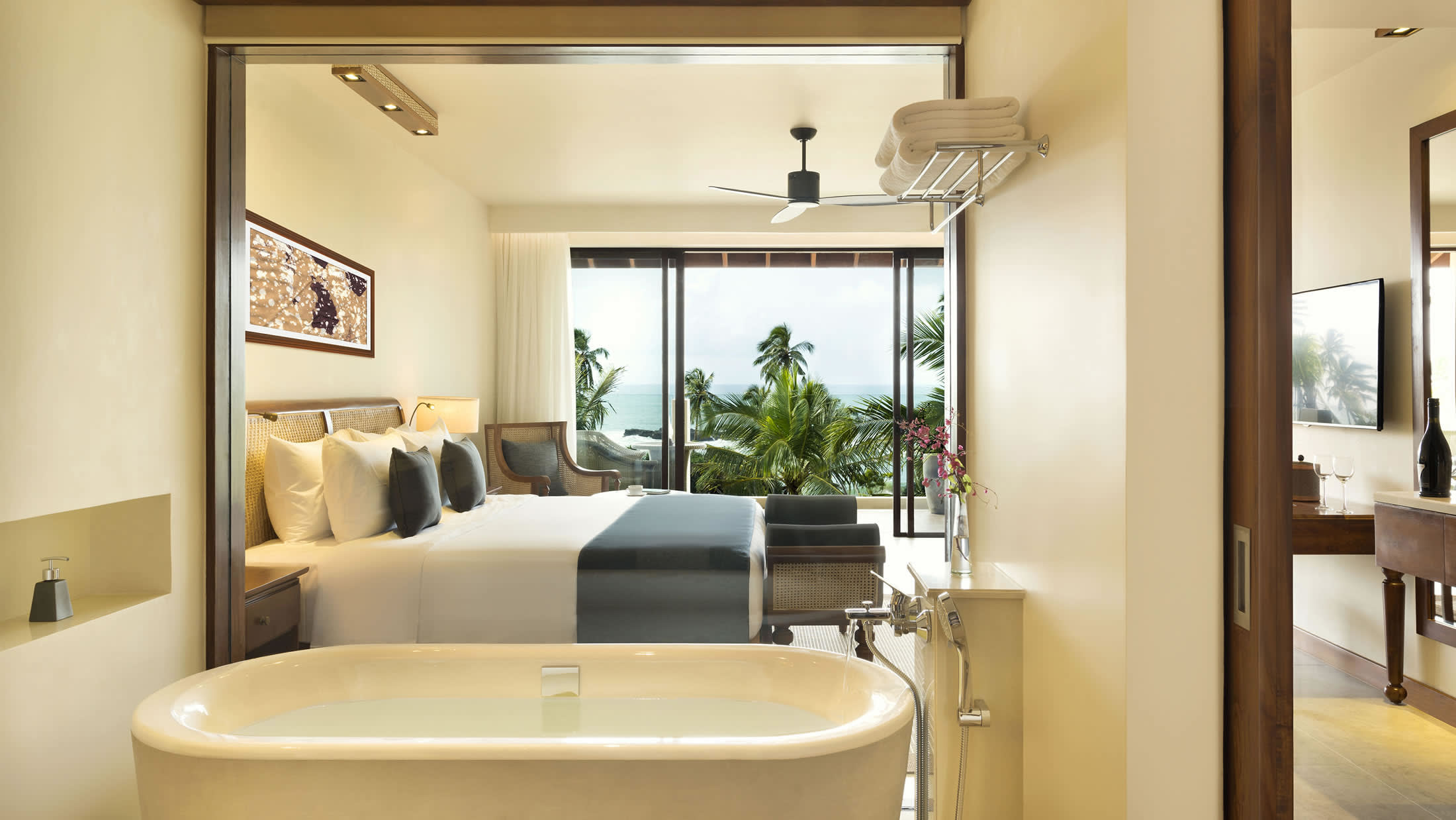 a white sink sitting under a mirror