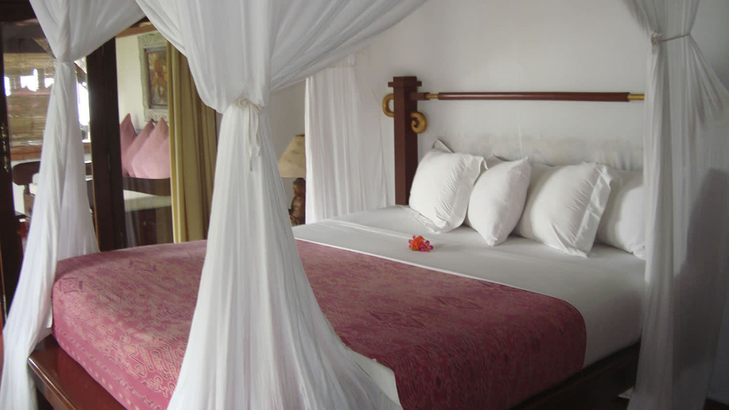 a bedroom with a bed and a chair in a room