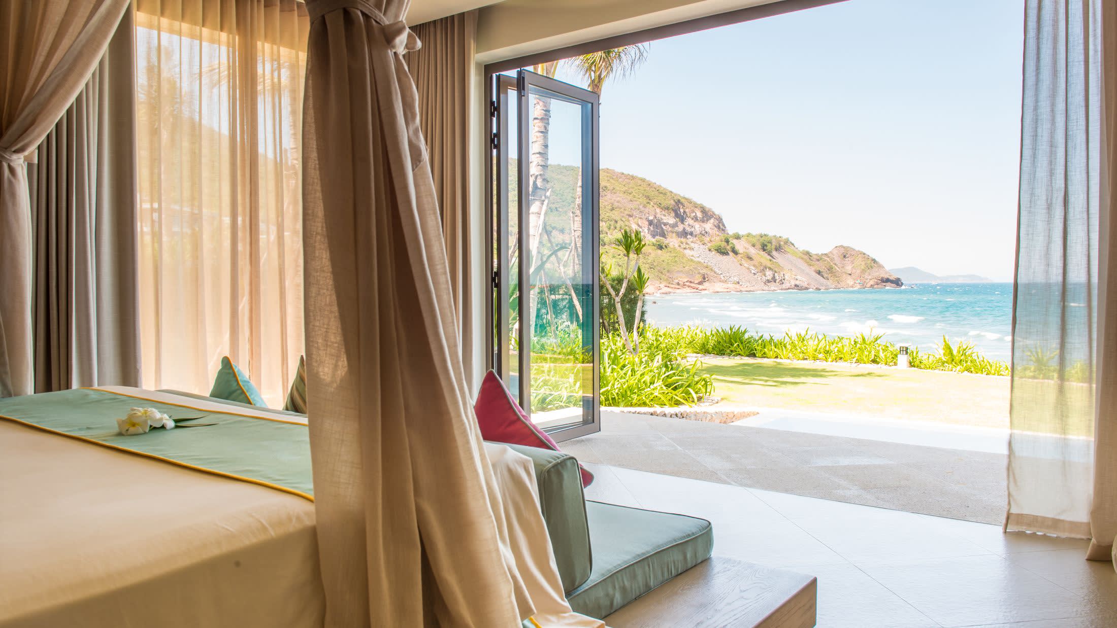 a bedroom with a bed and a chair in front of a window