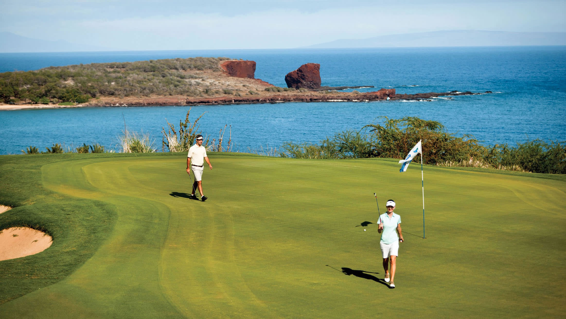 a group of people on a beach near a body of water