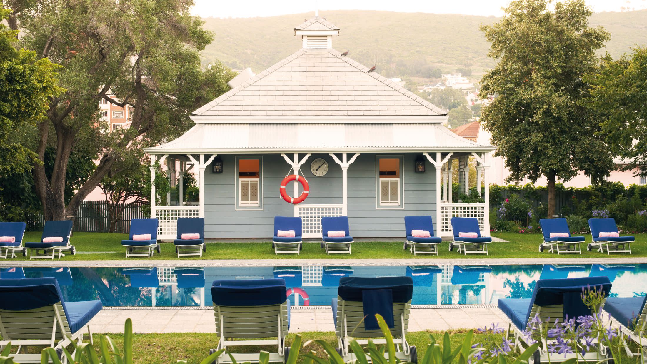 a blue bench in front of a house