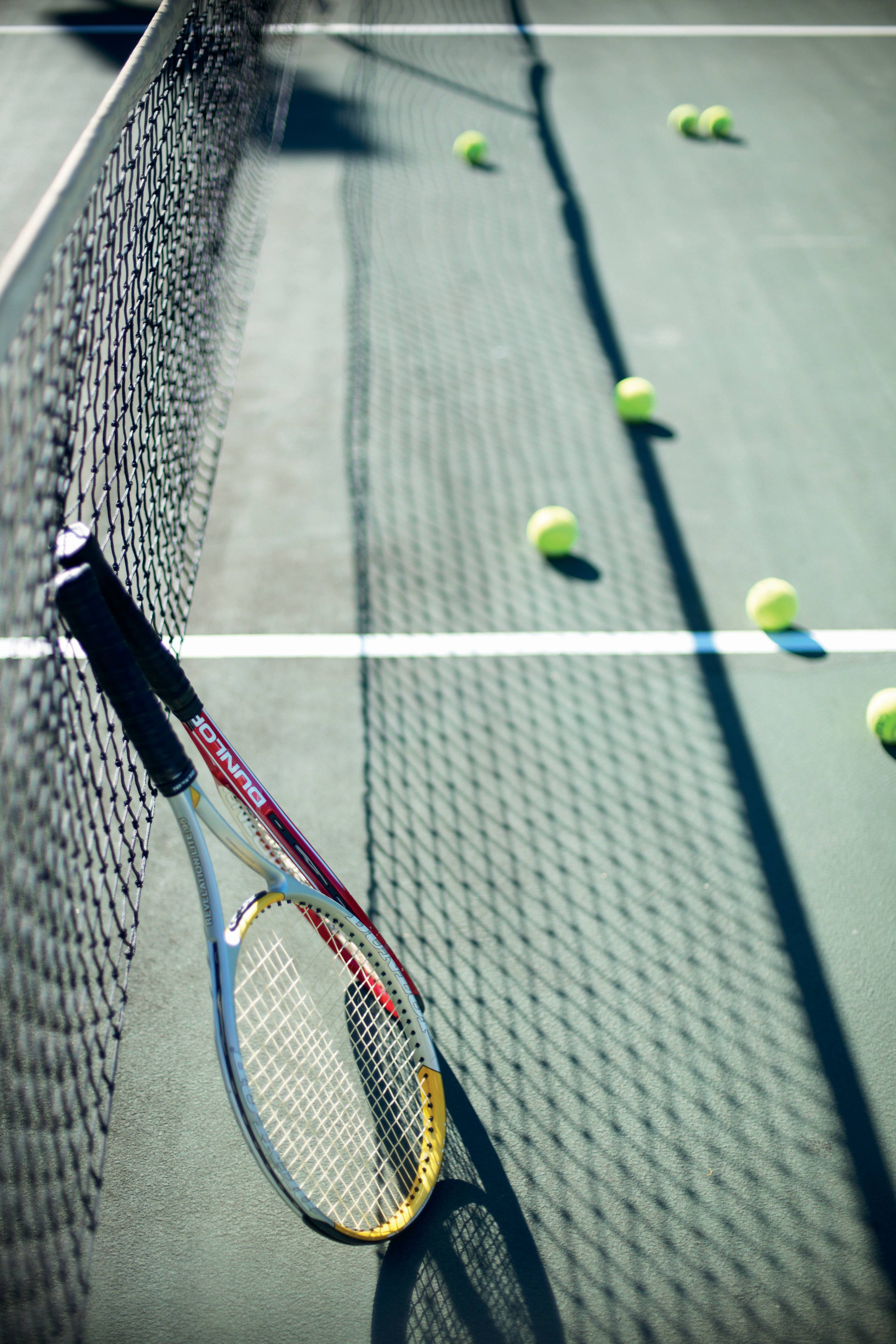 a person hitting a ball with a racket on a court