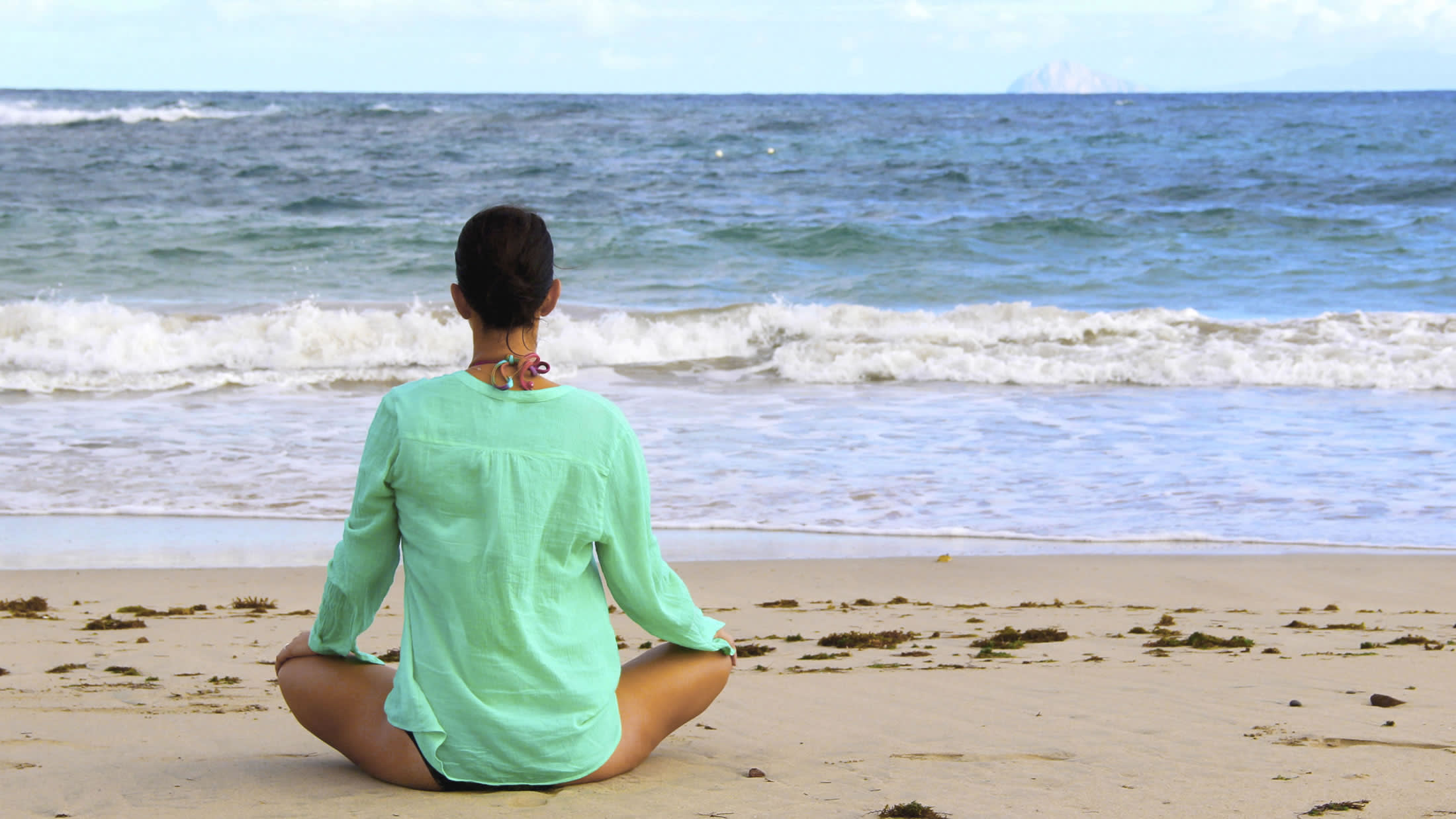 a young boy standing on a beach