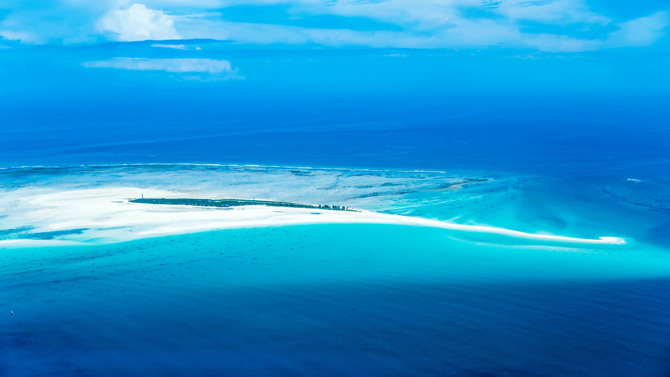 a group of clouds in the blue water