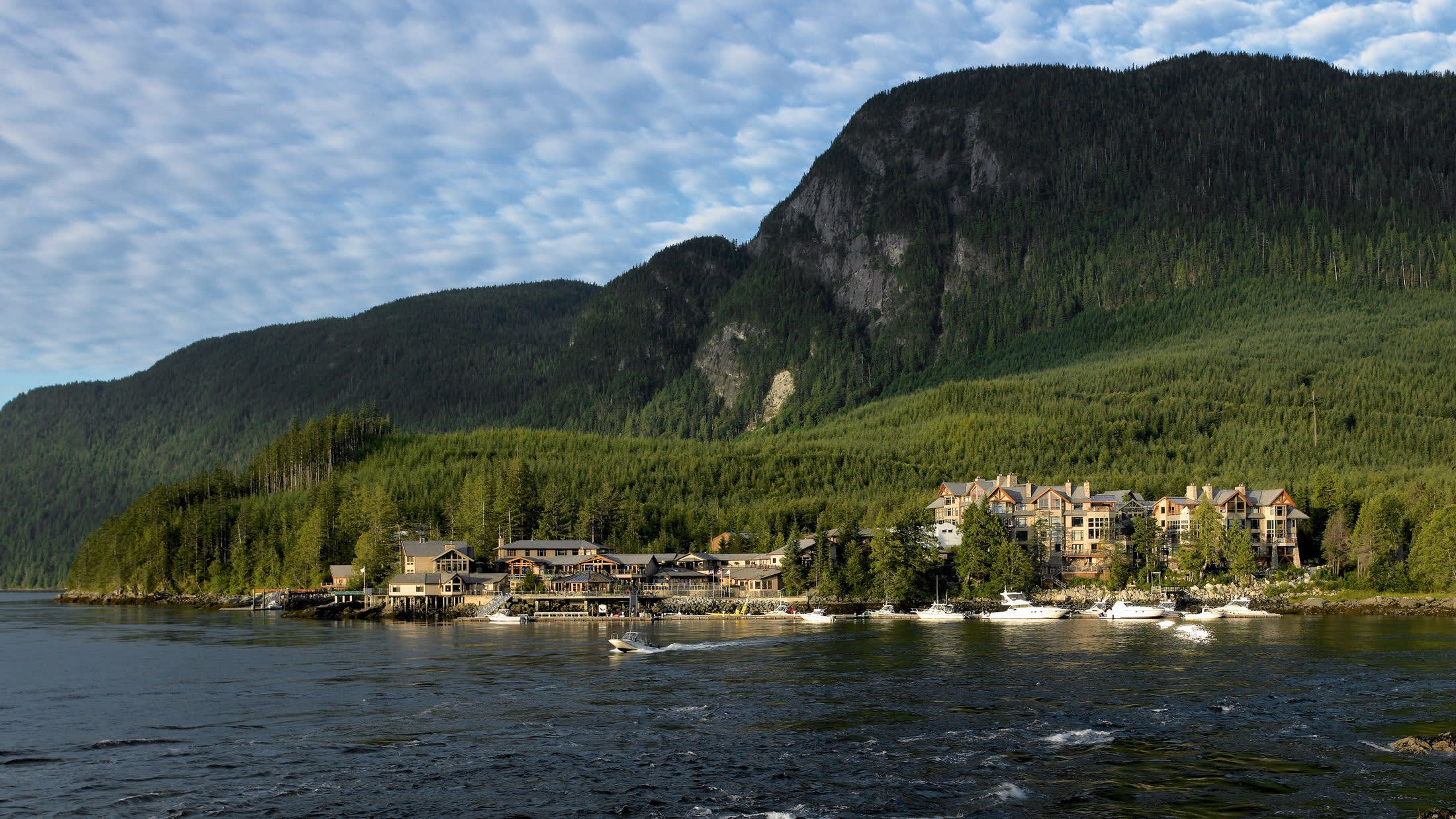 a large body of water with a mountain in the background