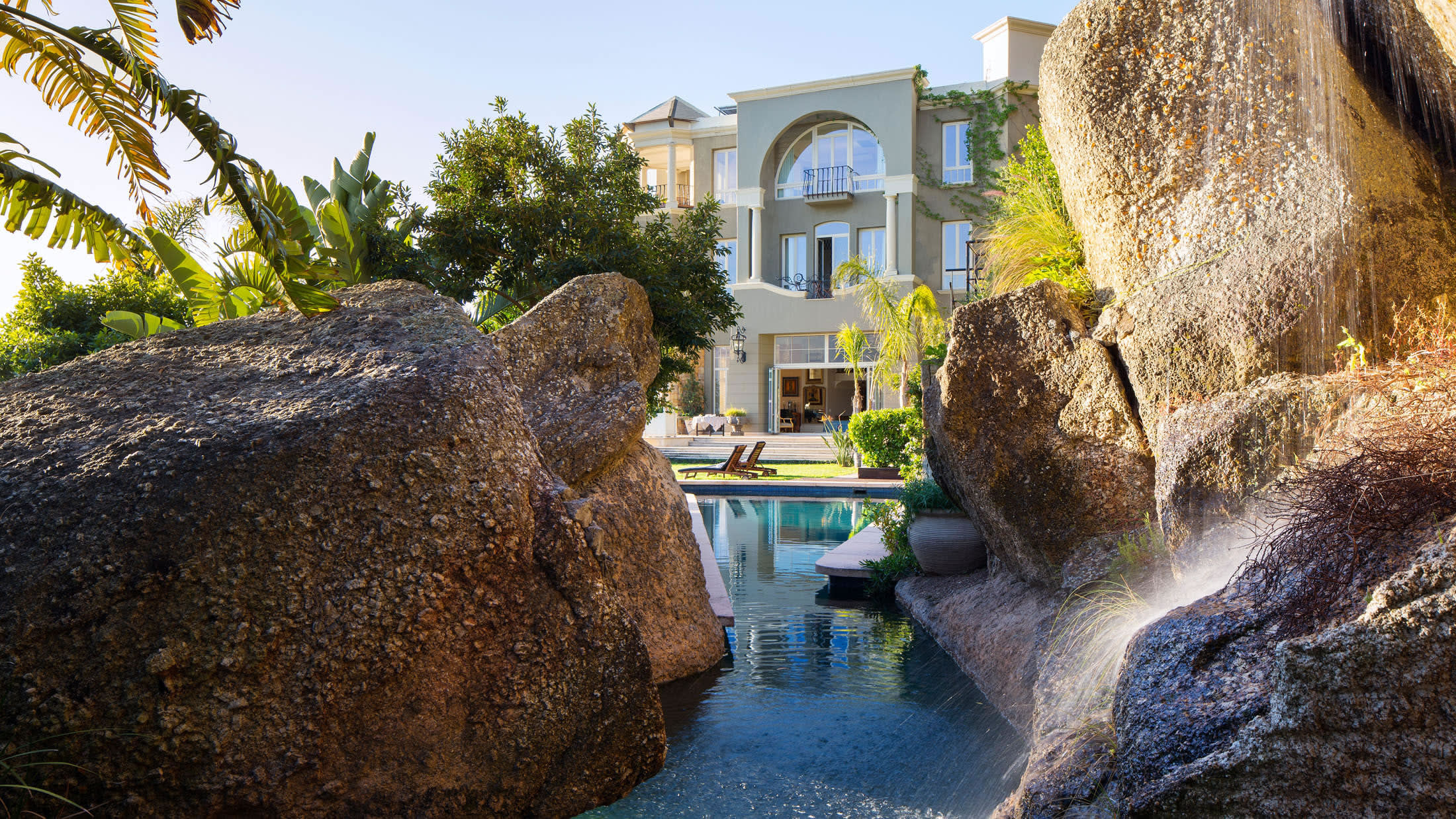 a close up of a stone building that has a large rock