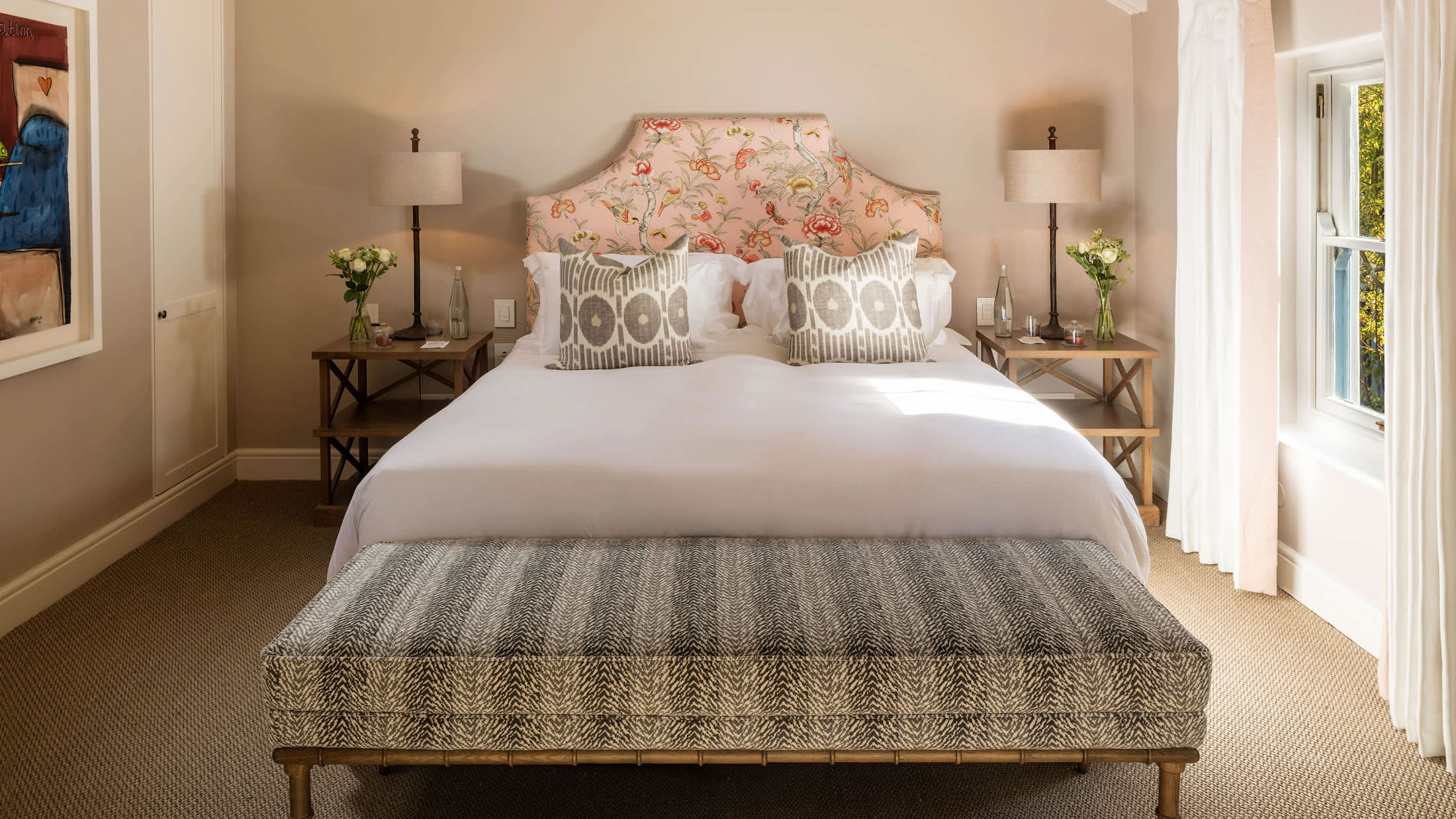 a bedroom with a bed and a chair in a room