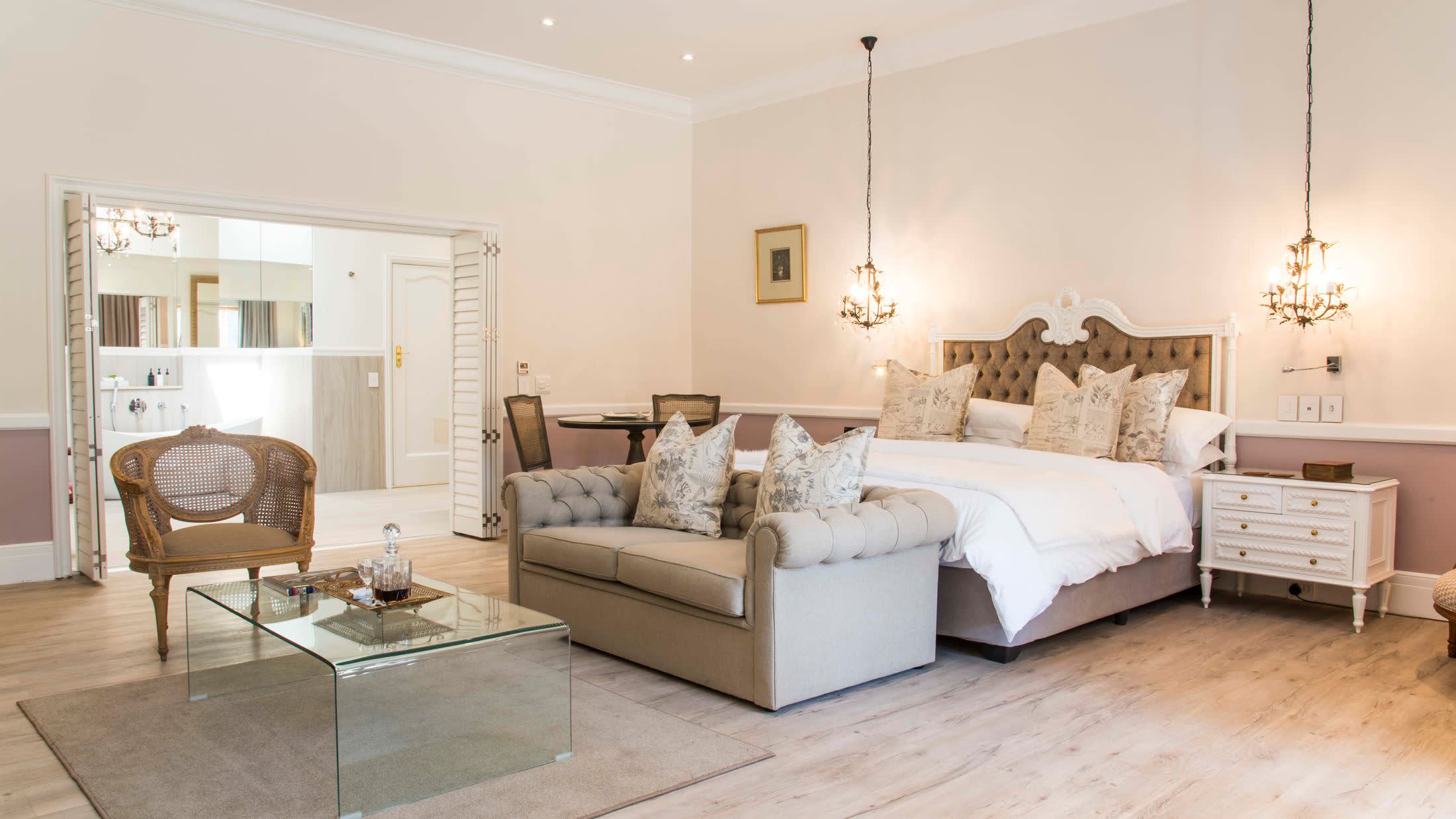 a living room filled with furniture and a bed