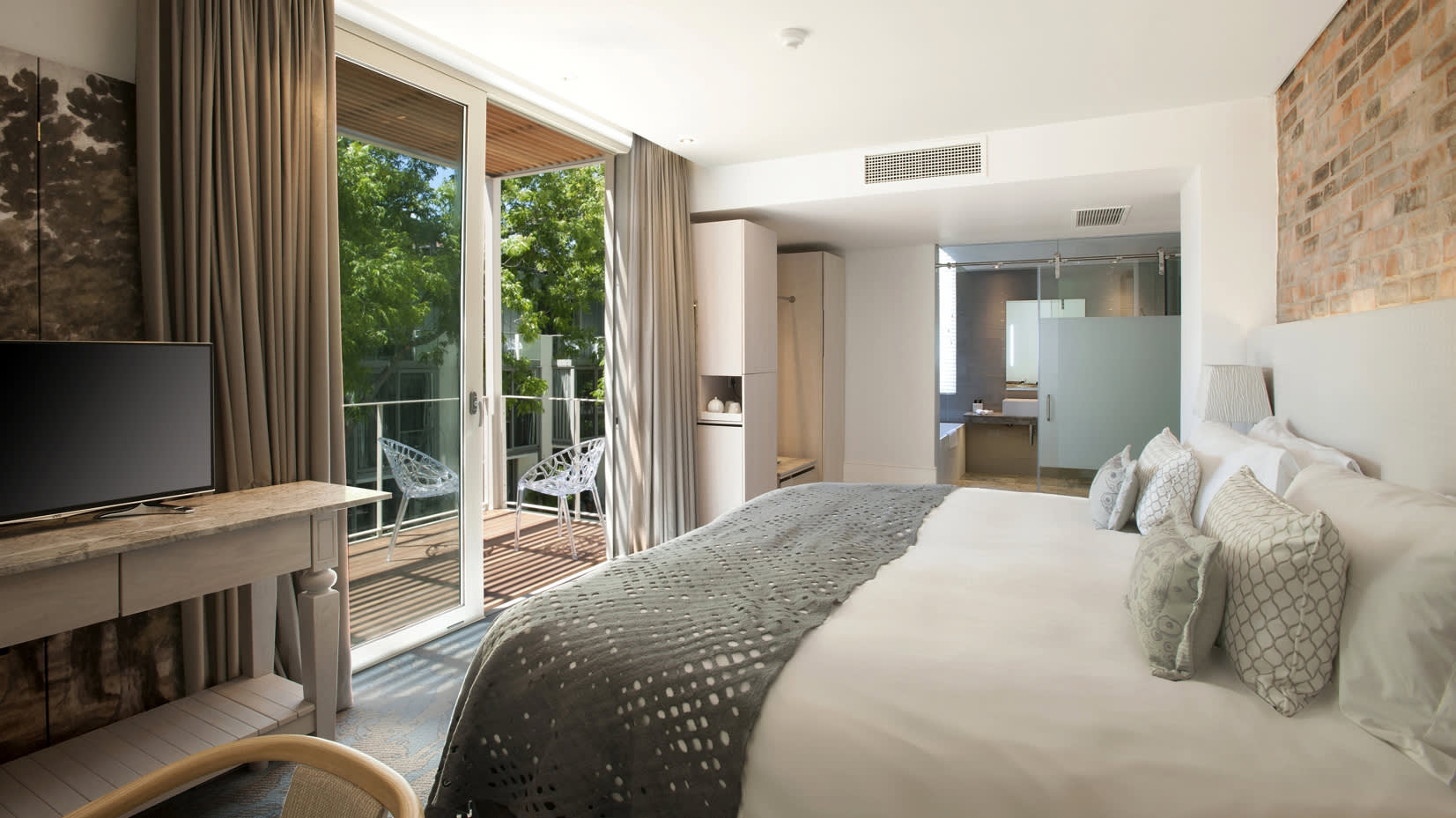 a bedroom with a large bed in a hotel room