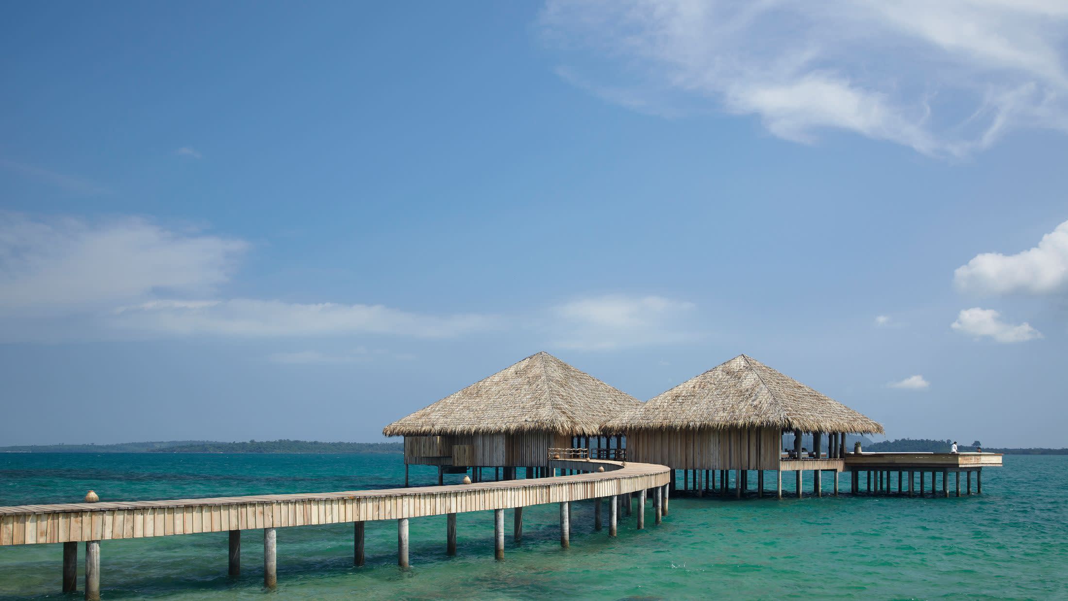 a wooden pier next to a body of water