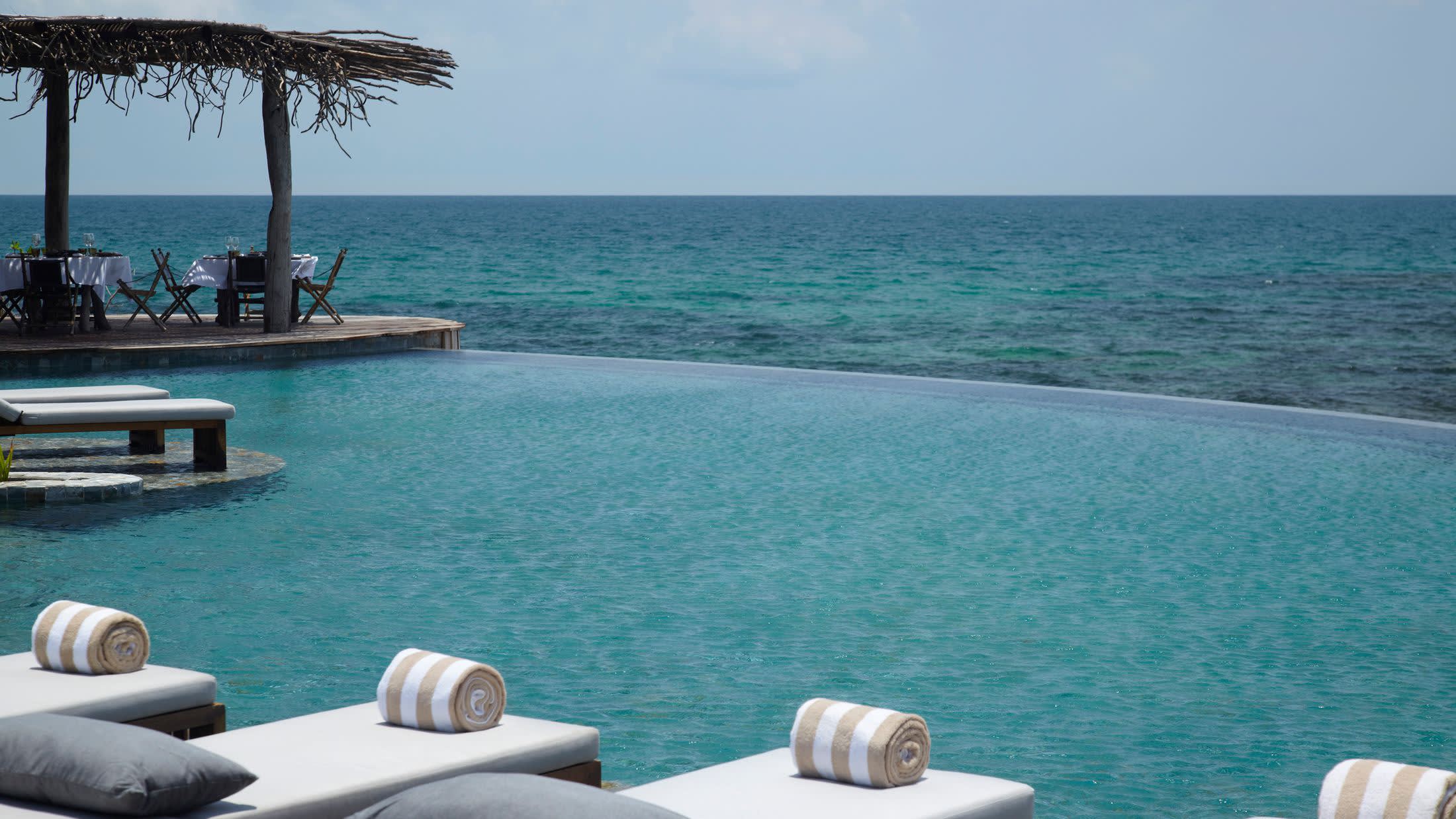 a chair sitting in front of a body of water