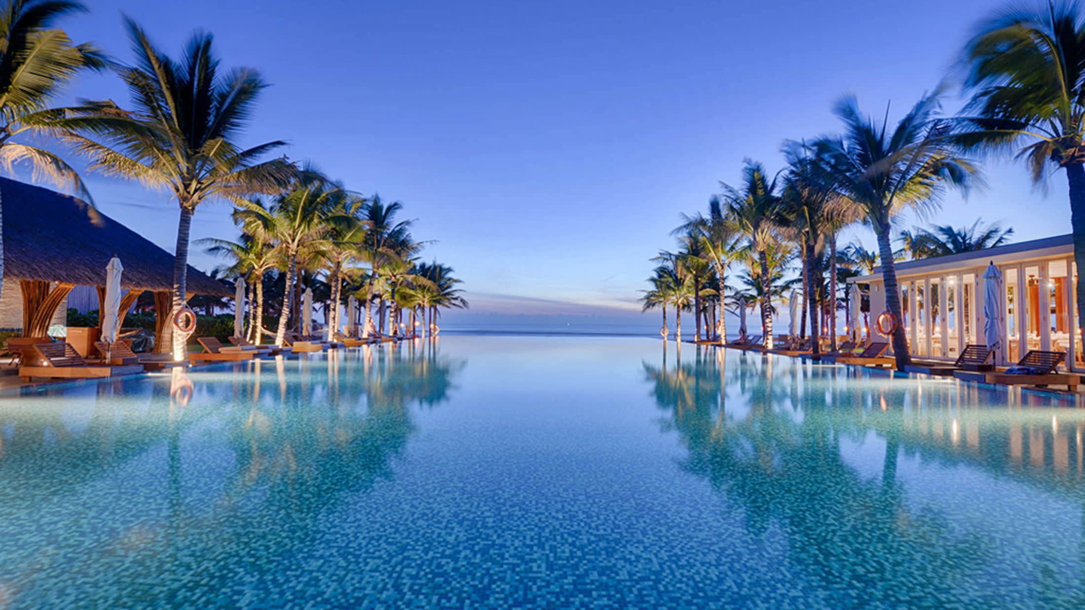 a body of water surrounded by palm trees