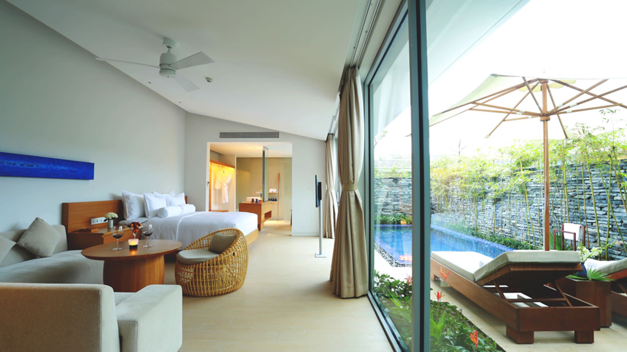 a view of a living room filled with furniture and a large window