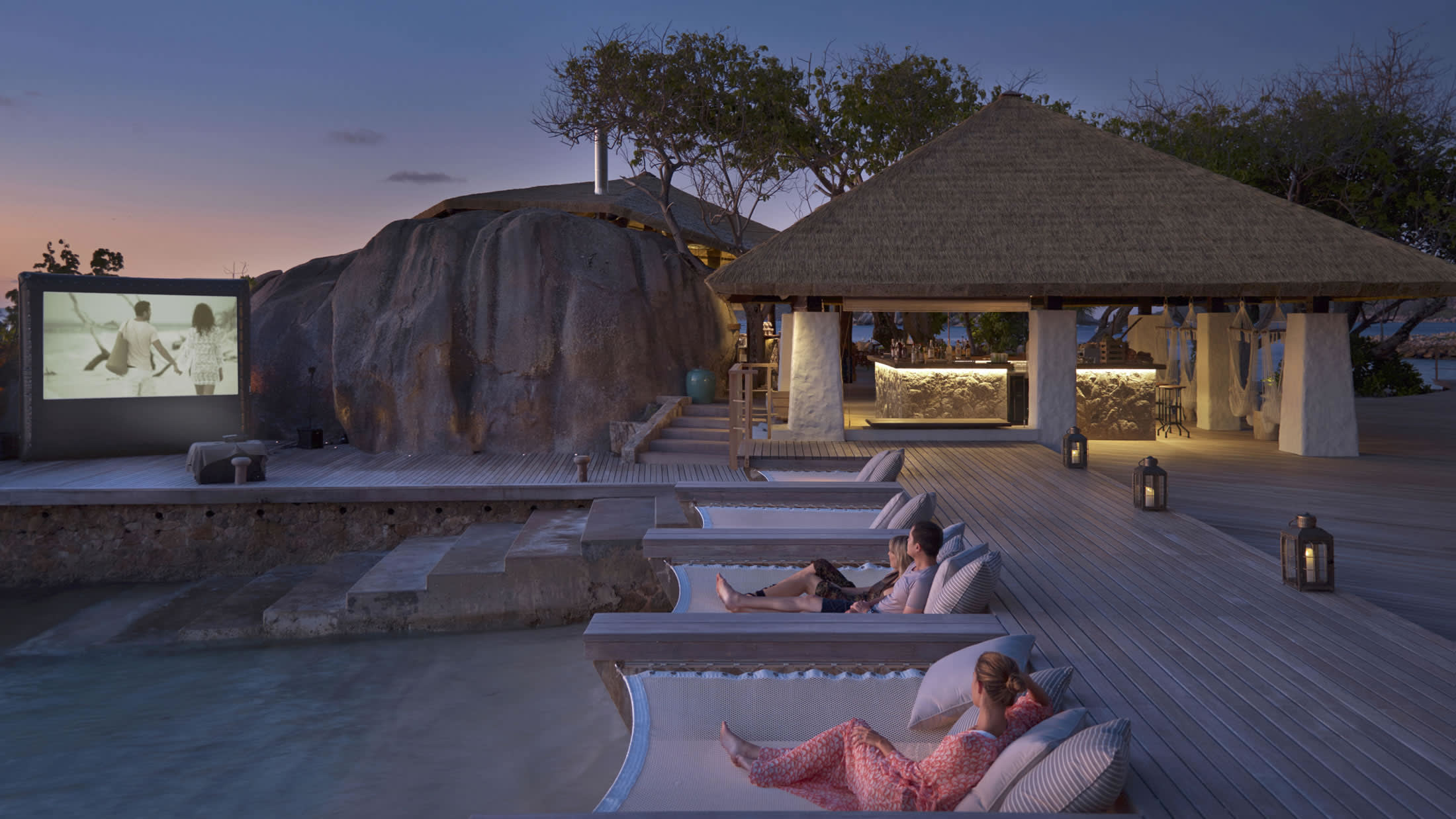 a person sitting on a bench in front of a house