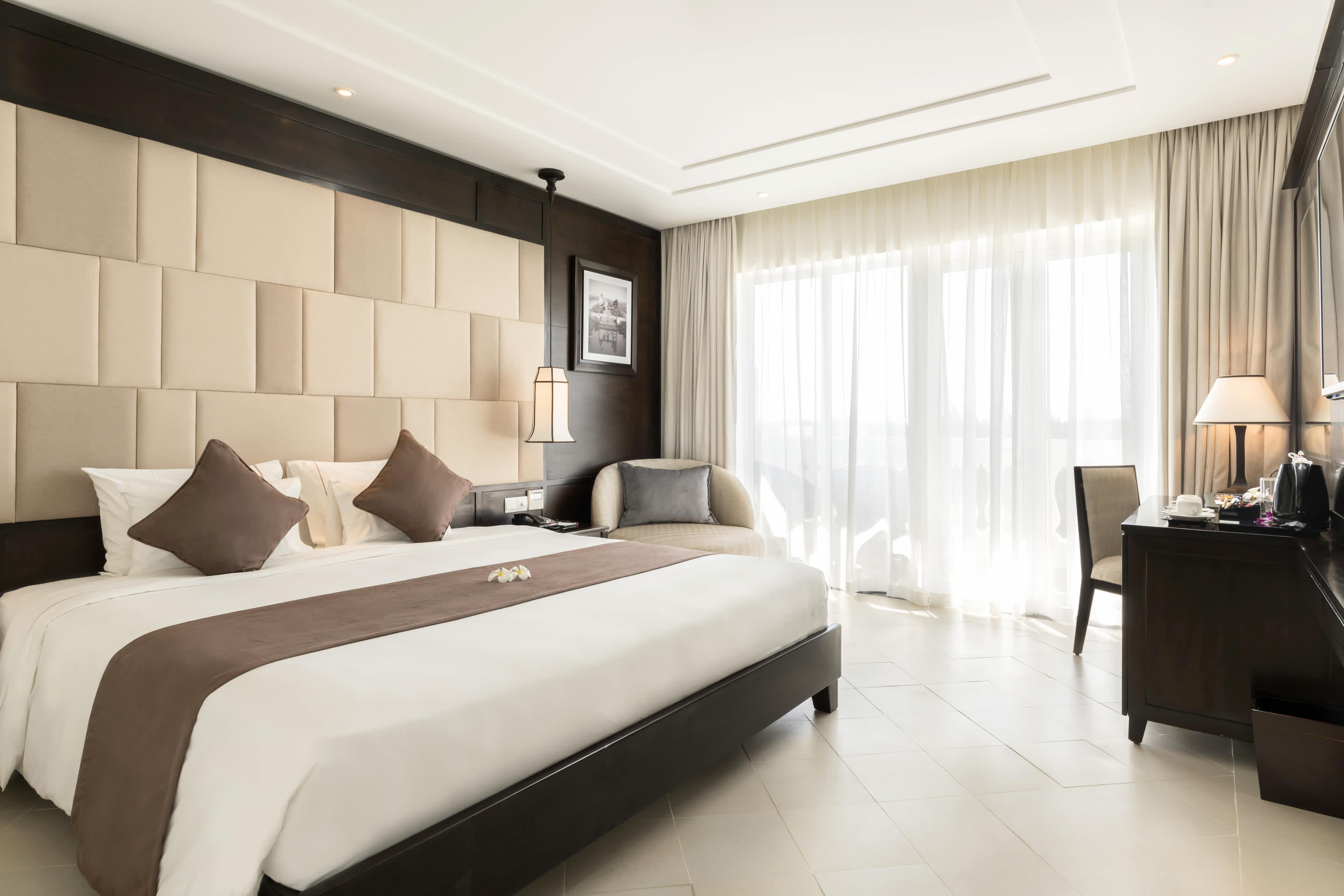 a bedroom with a large bed in a hotel room