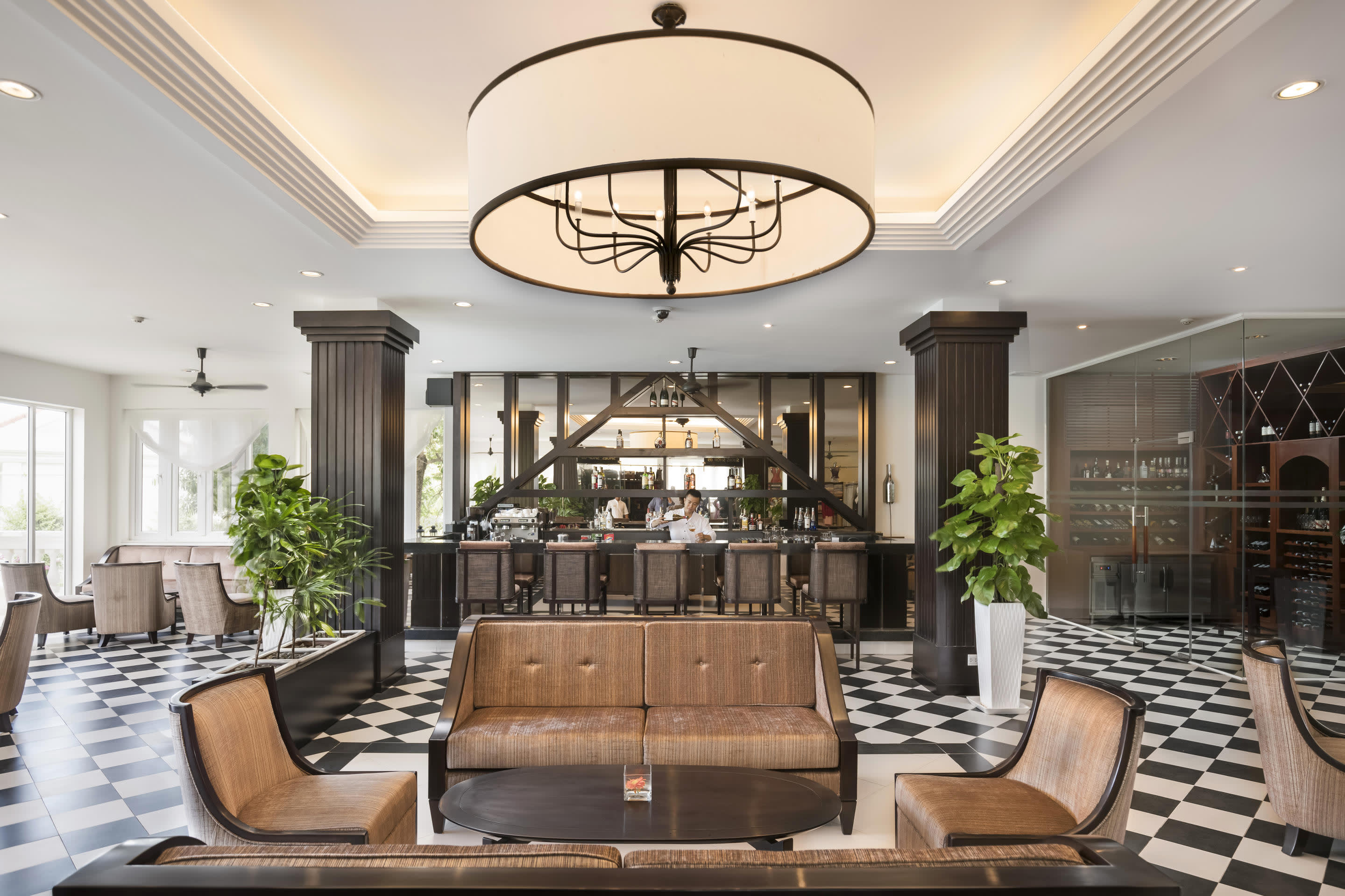 a living room filled with furniture and vase on a table