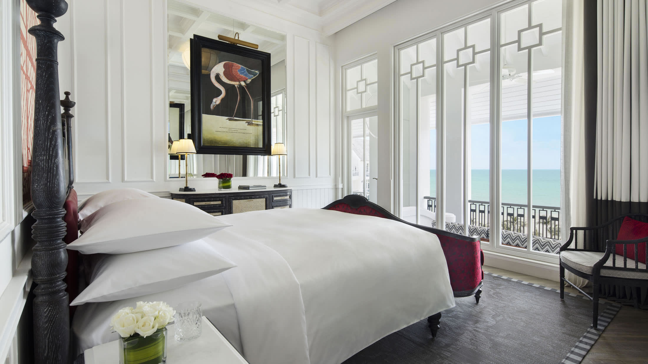 a large white bed sitting in a room