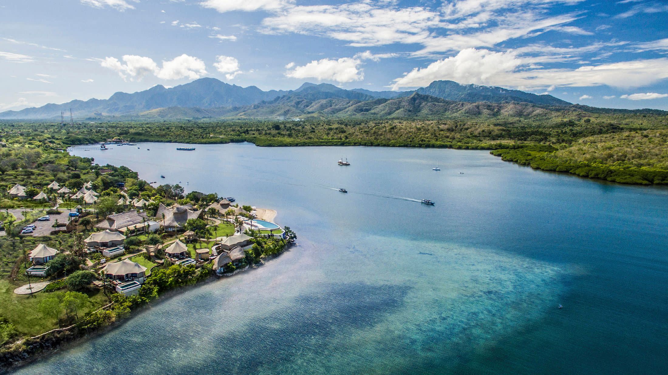 a body of water with a mountain in the background