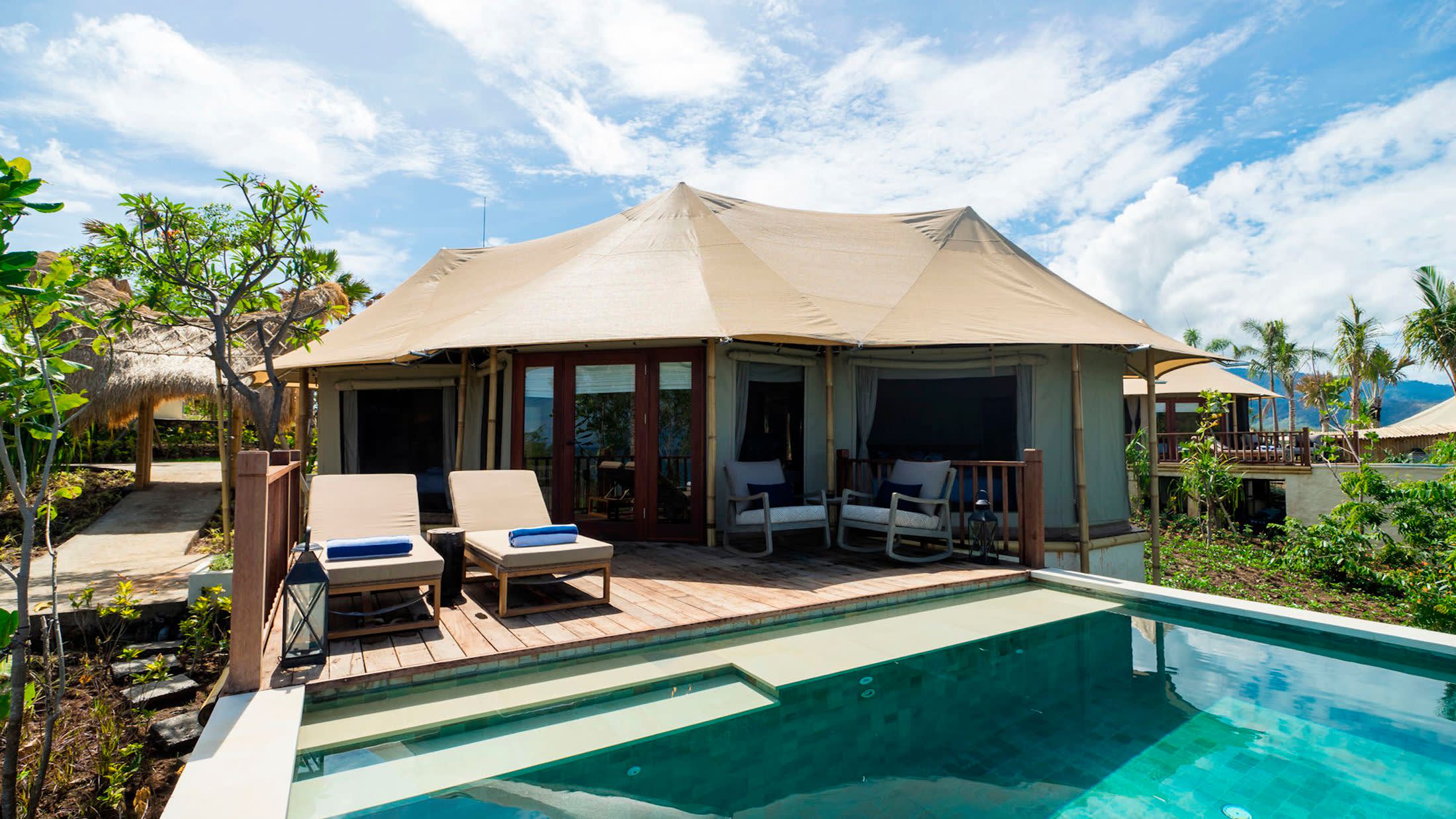 a house with a pool outside of a building