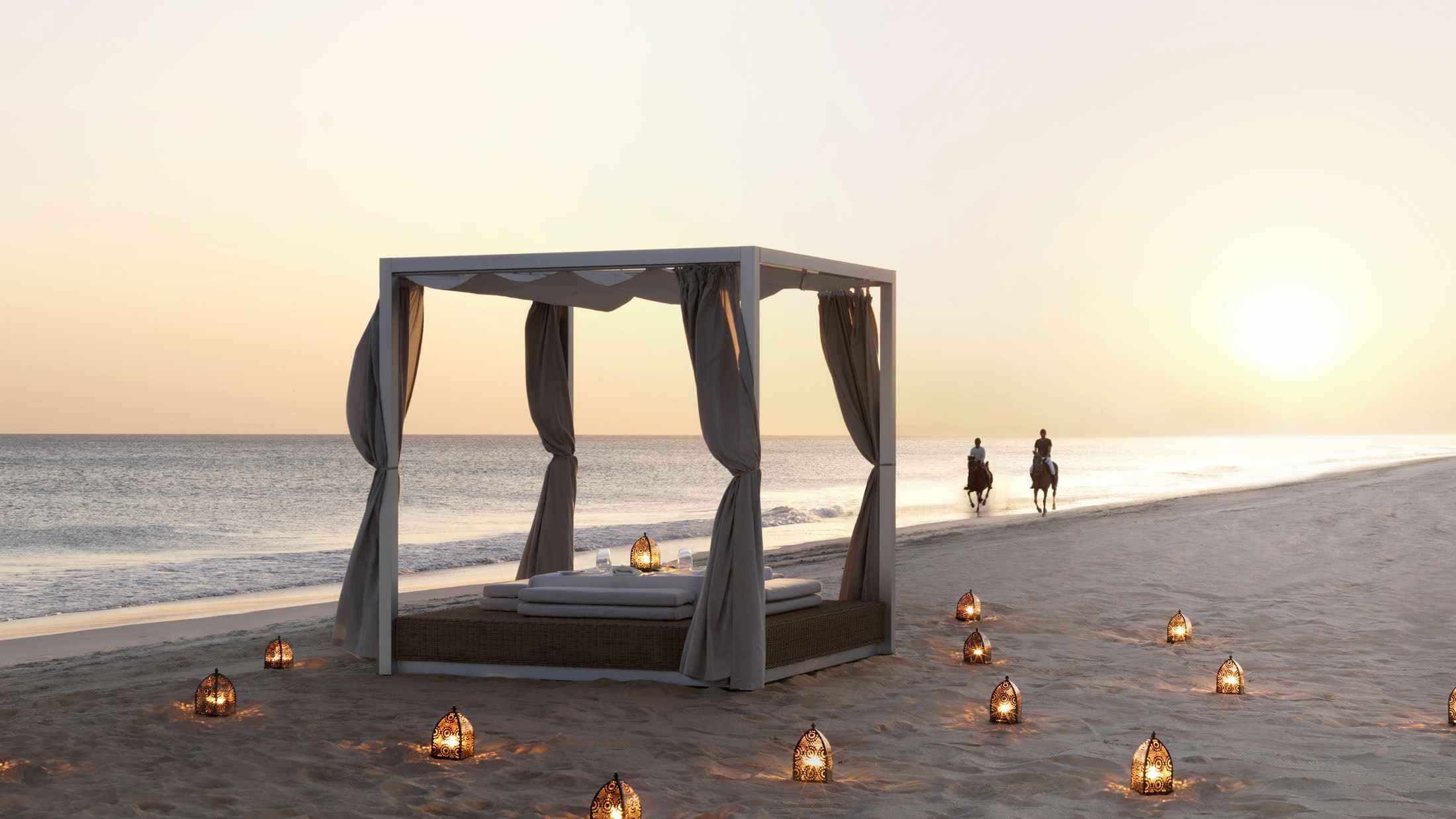 a group of people on a beach near a body of water