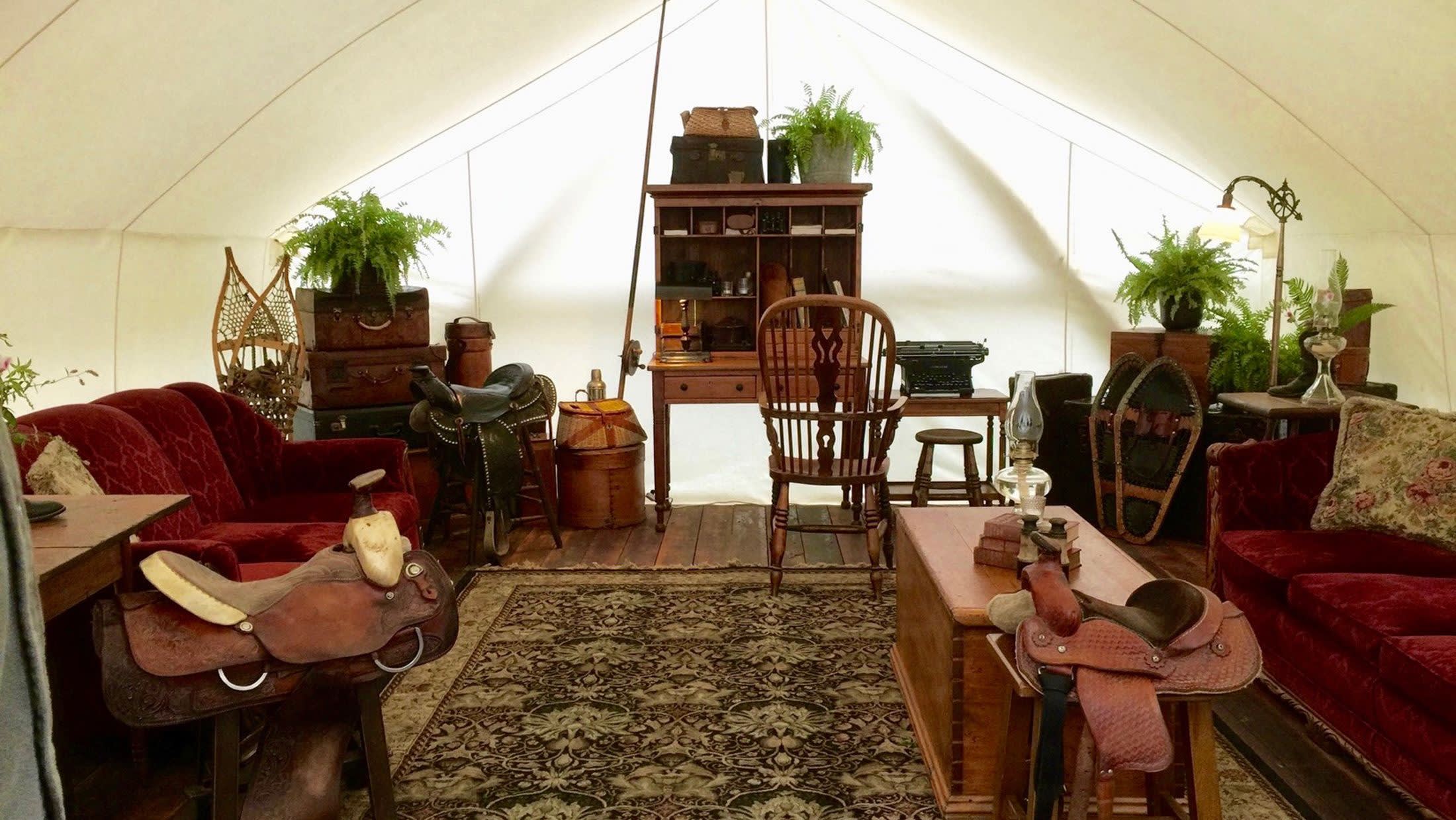 a living room filled with furniture and vase of flowers on a table