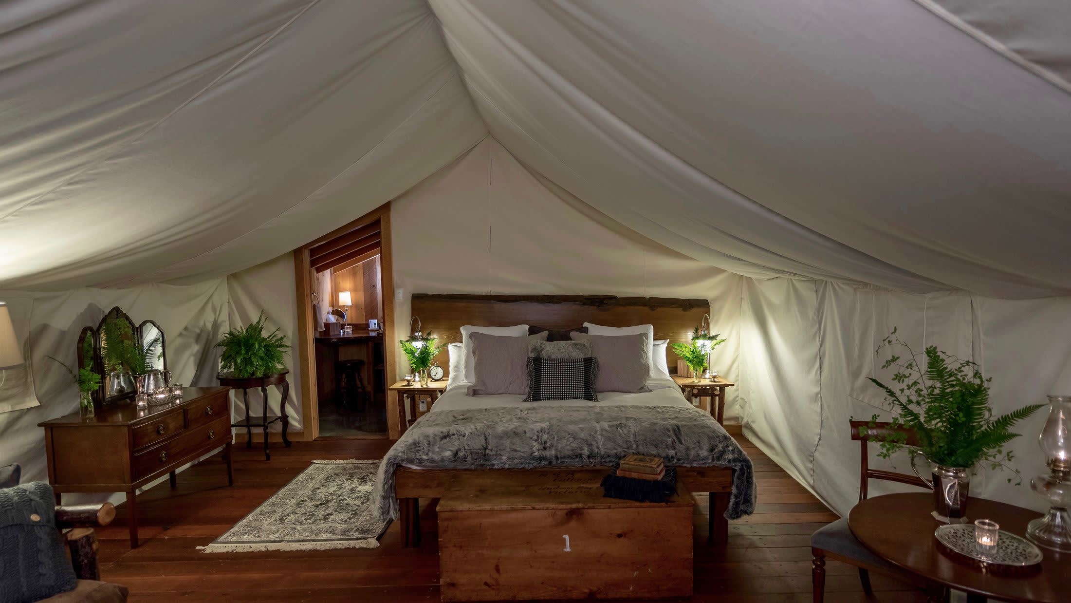 a living room filled with furniture and vase of flowers on a table