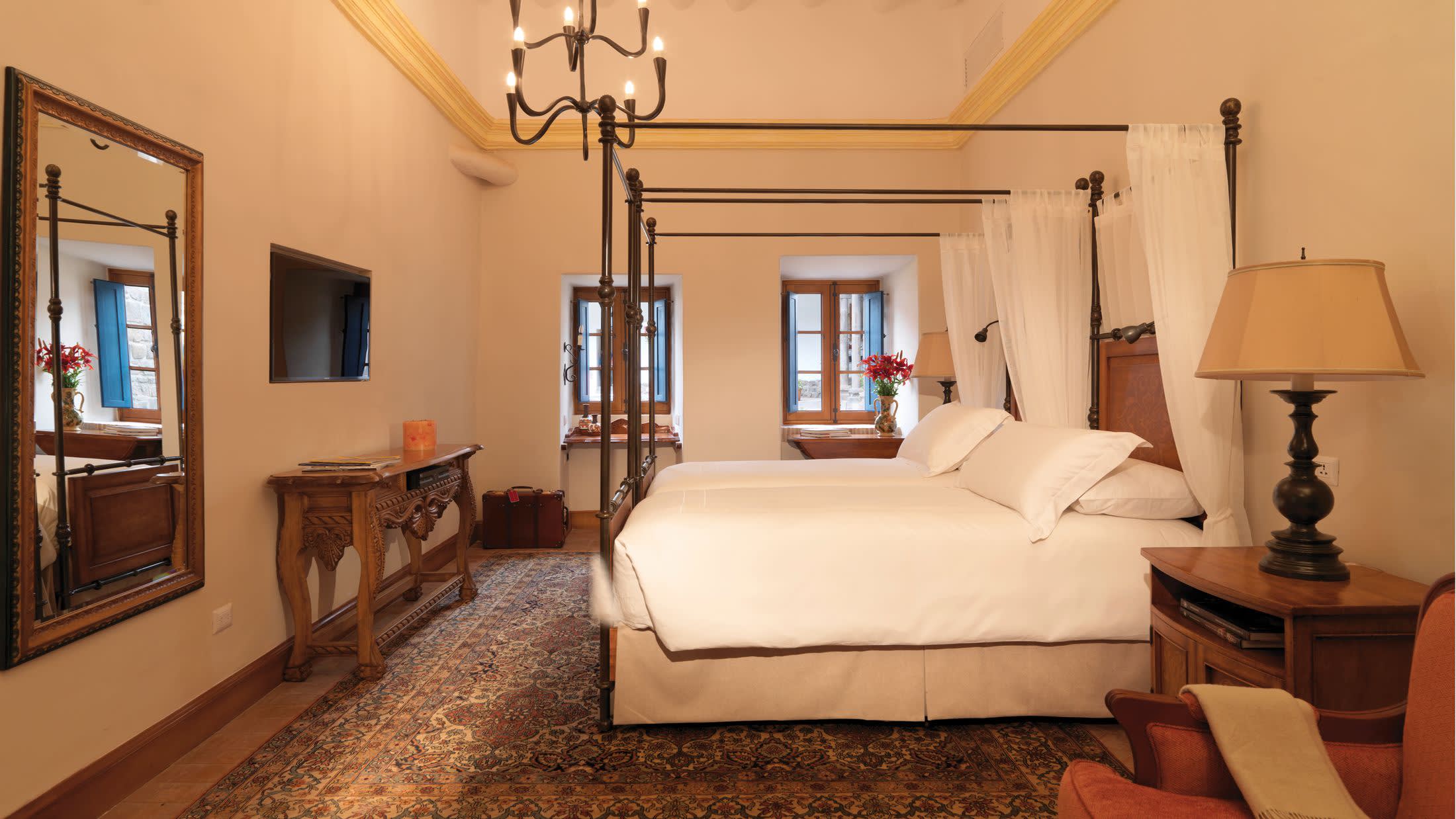 a bedroom with a bed and desk in a room