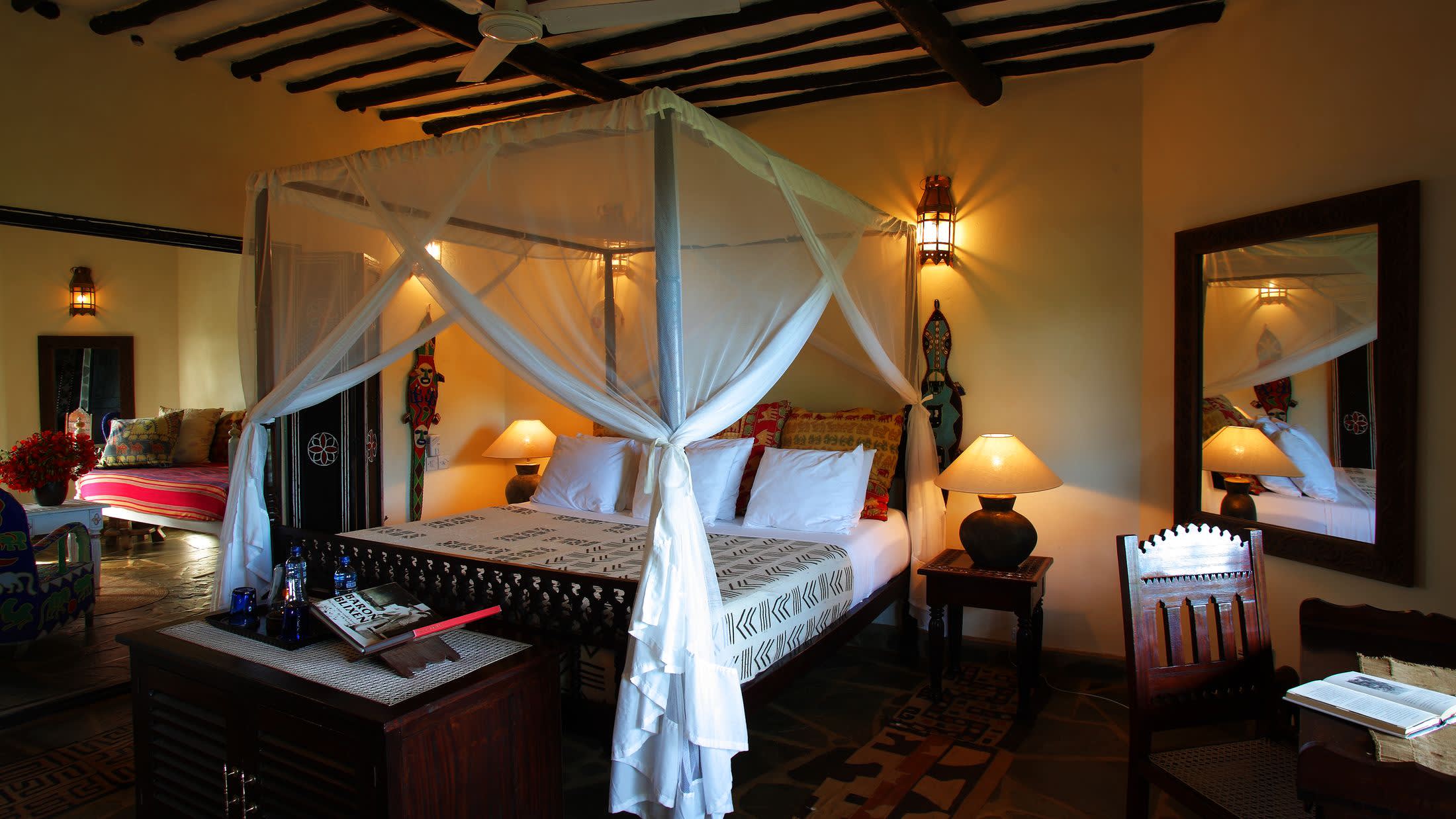 a bedroom with a bed and desk in a room