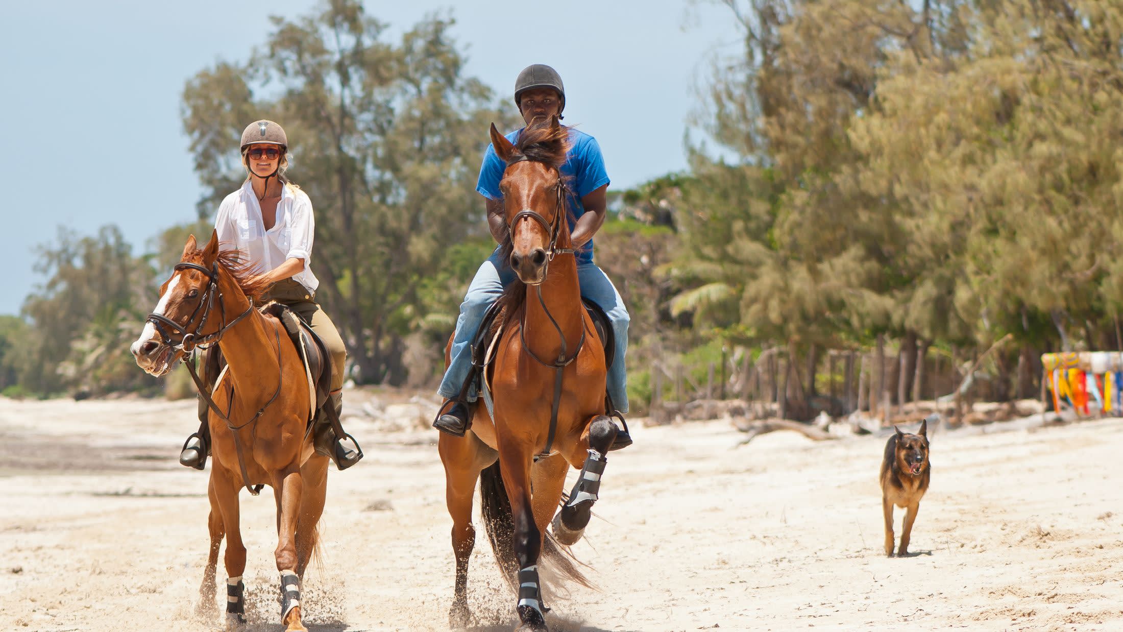 a man riding a horse on a beach