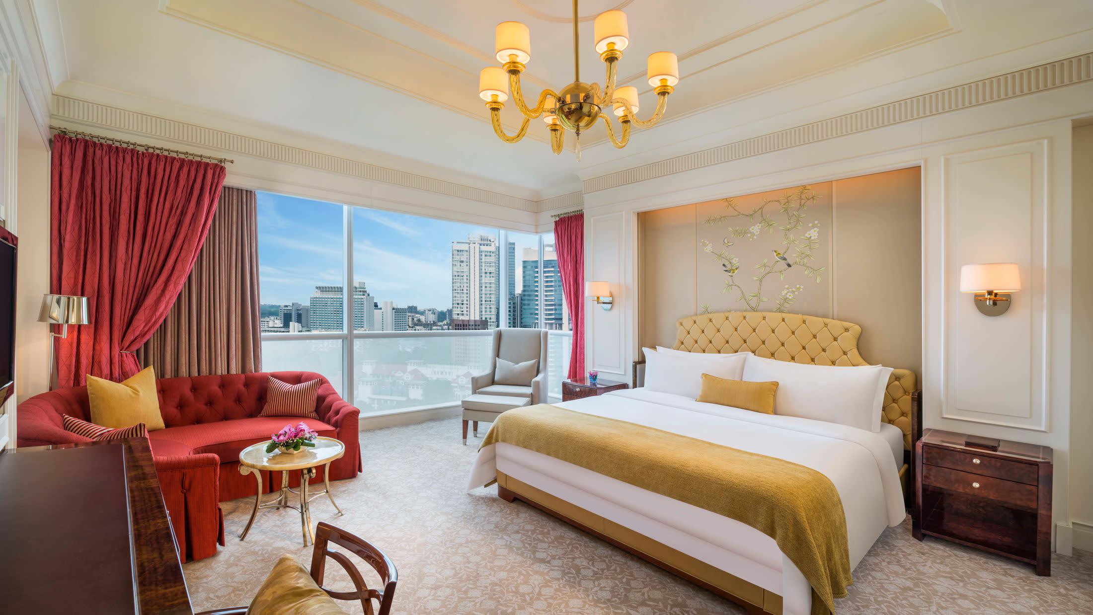 a bedroom with a bed and a chair in a room