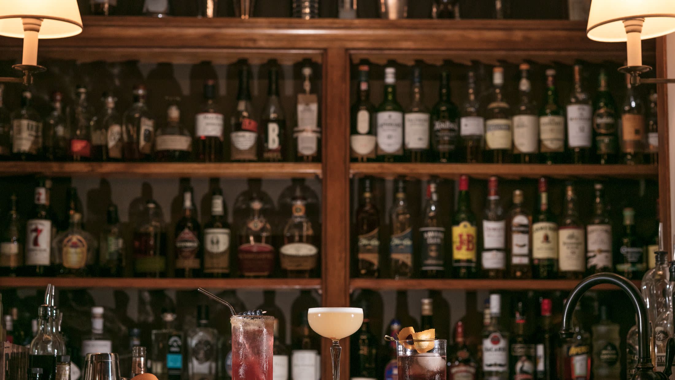 a row of beer glasses on a shelf