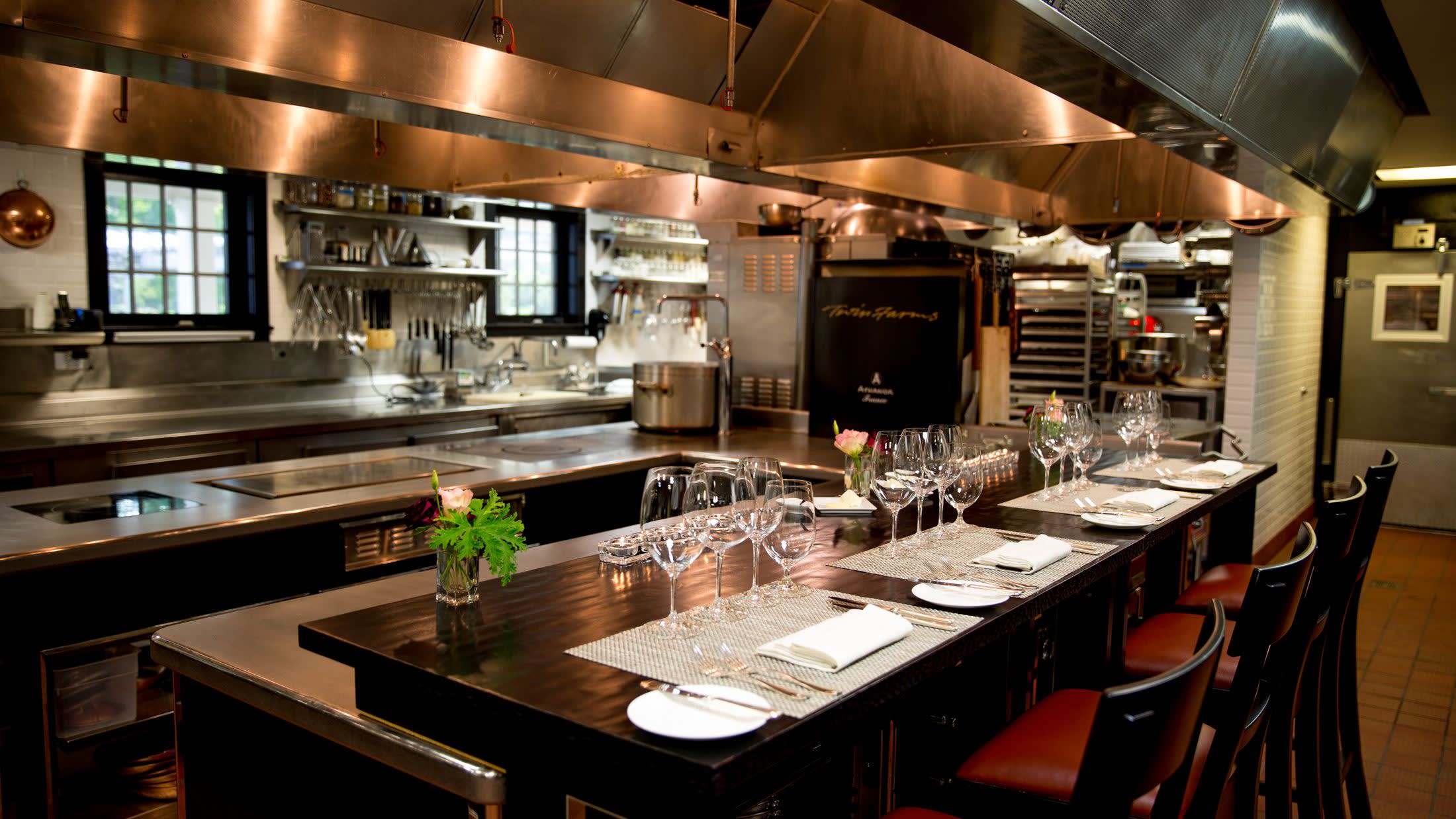 a large commercial kitchen with stainless steel appliances