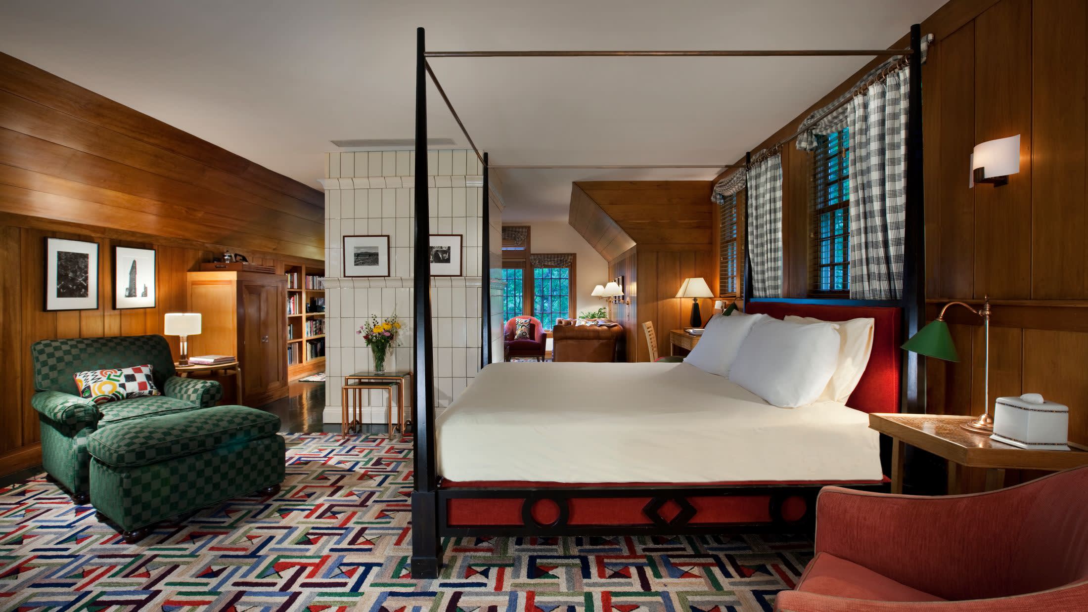 a bedroom with a bed and desk in a room