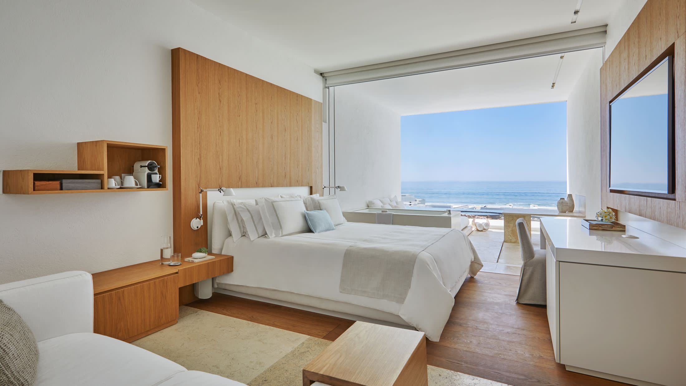 a living room with a bed and a large window