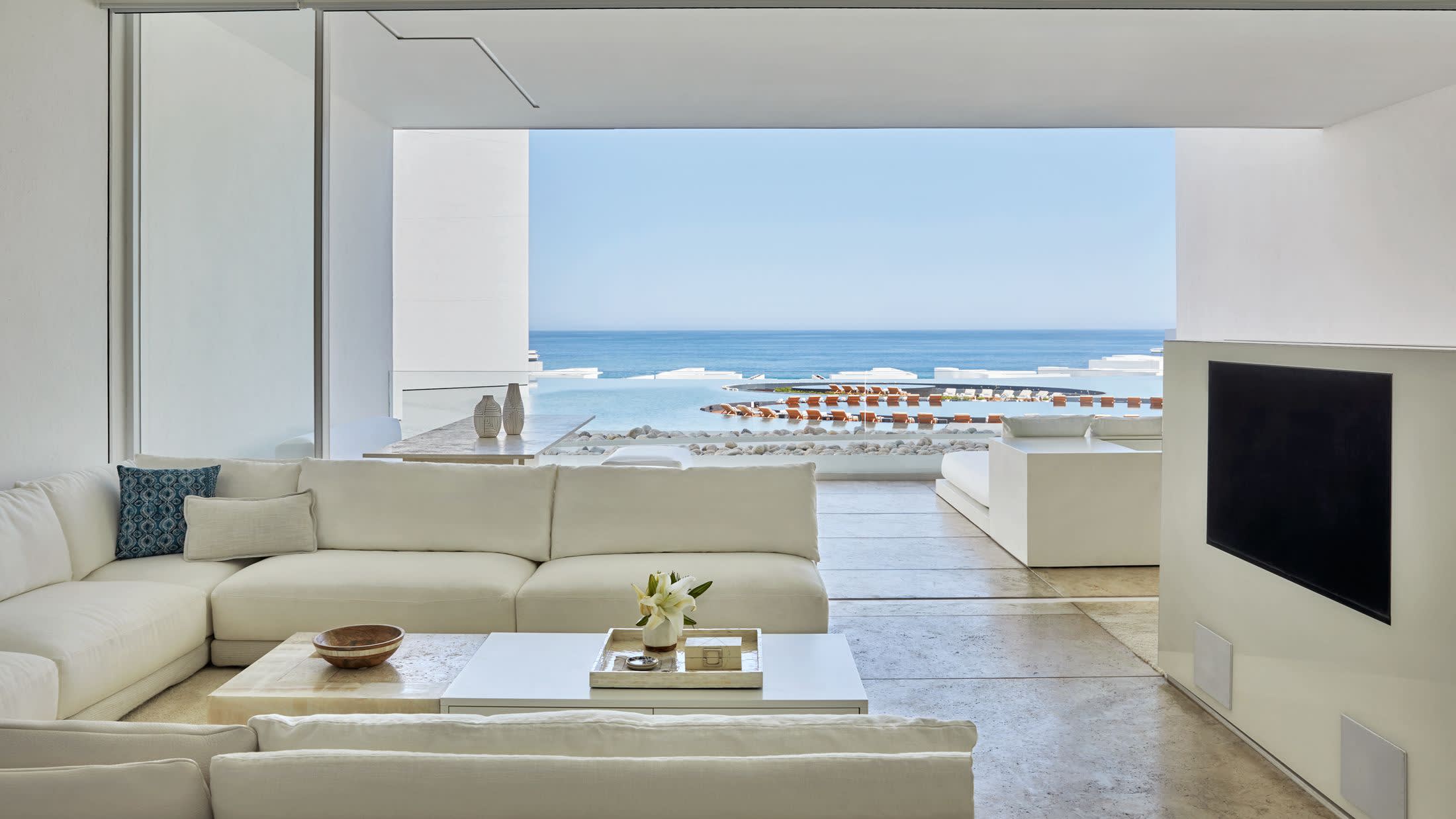 a living room filled with furniture and a large window