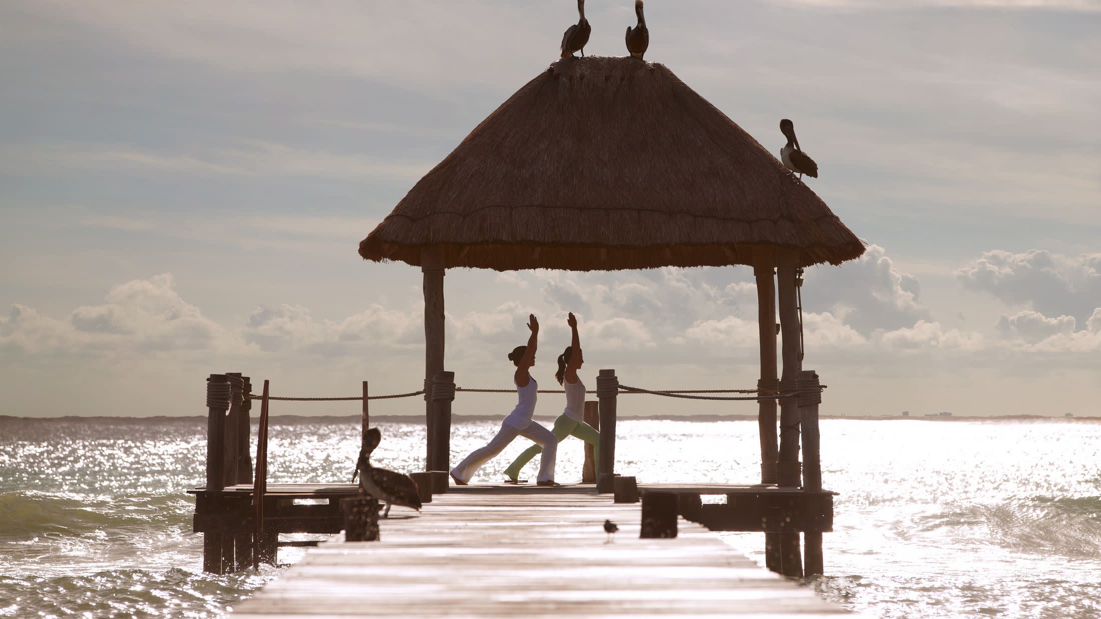 a wooden pier next to a body of water