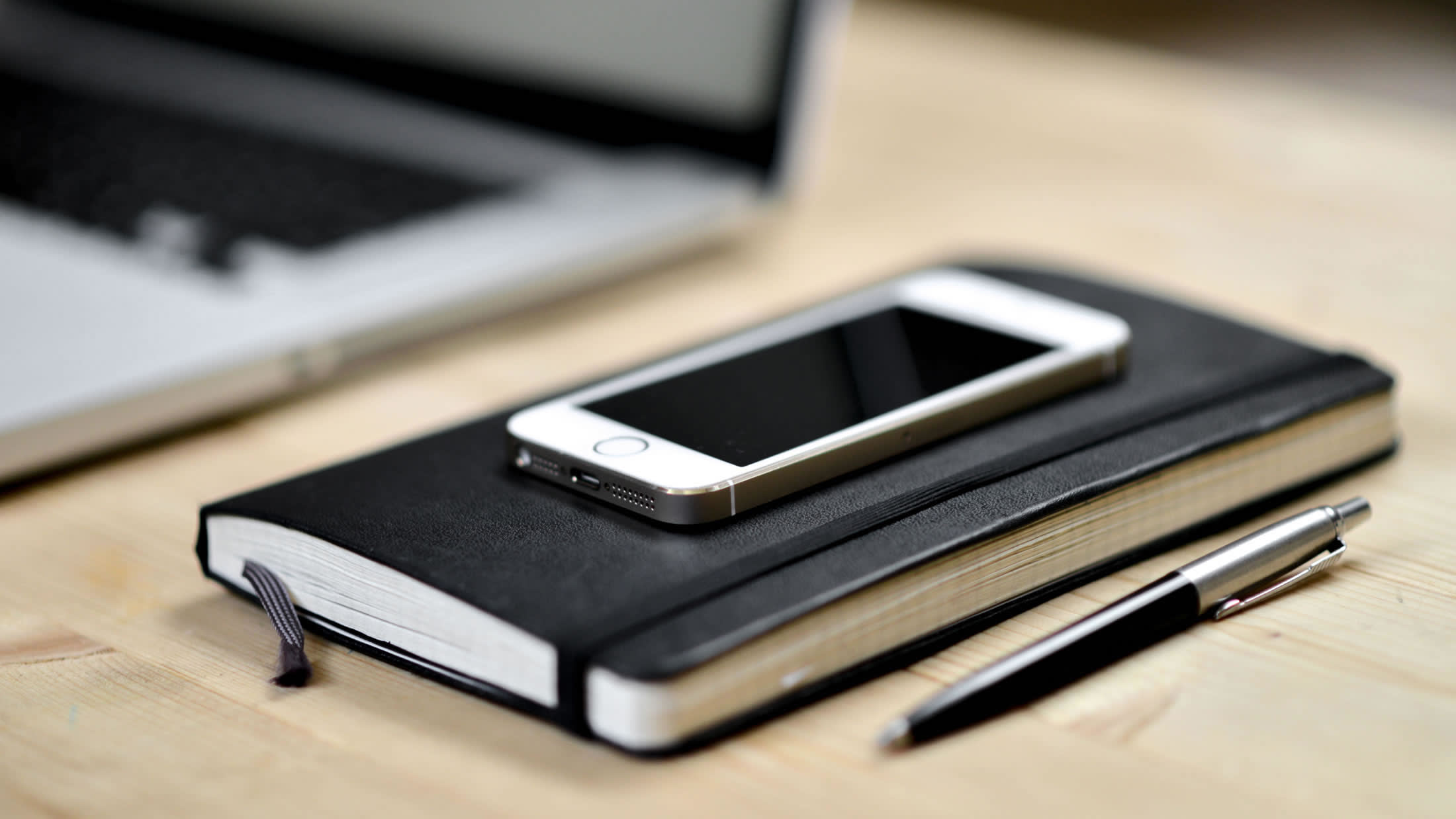 a laptop computer sitting on top of a wooden table