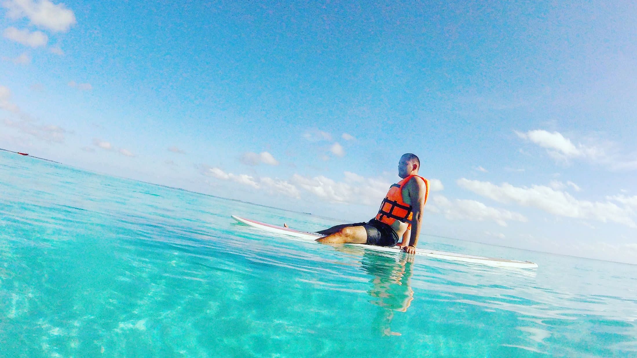 a man riding a wave on a surfboard in the water