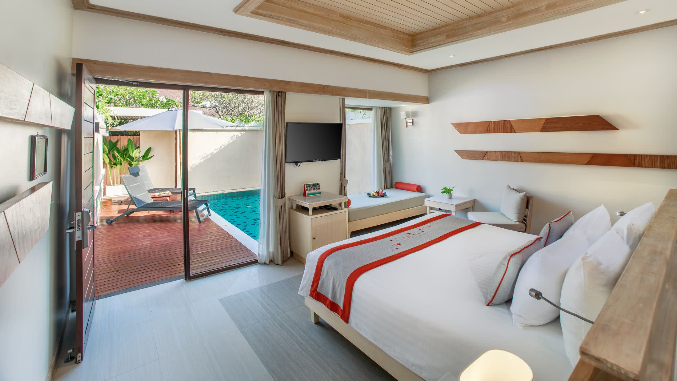 a bedroom with a bed and desk in a room