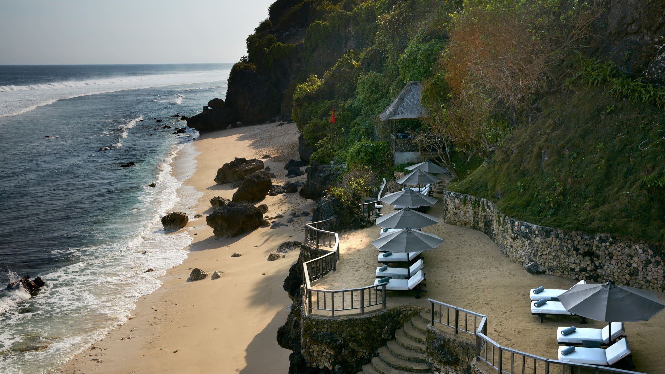 a rocky beach next to a body of water