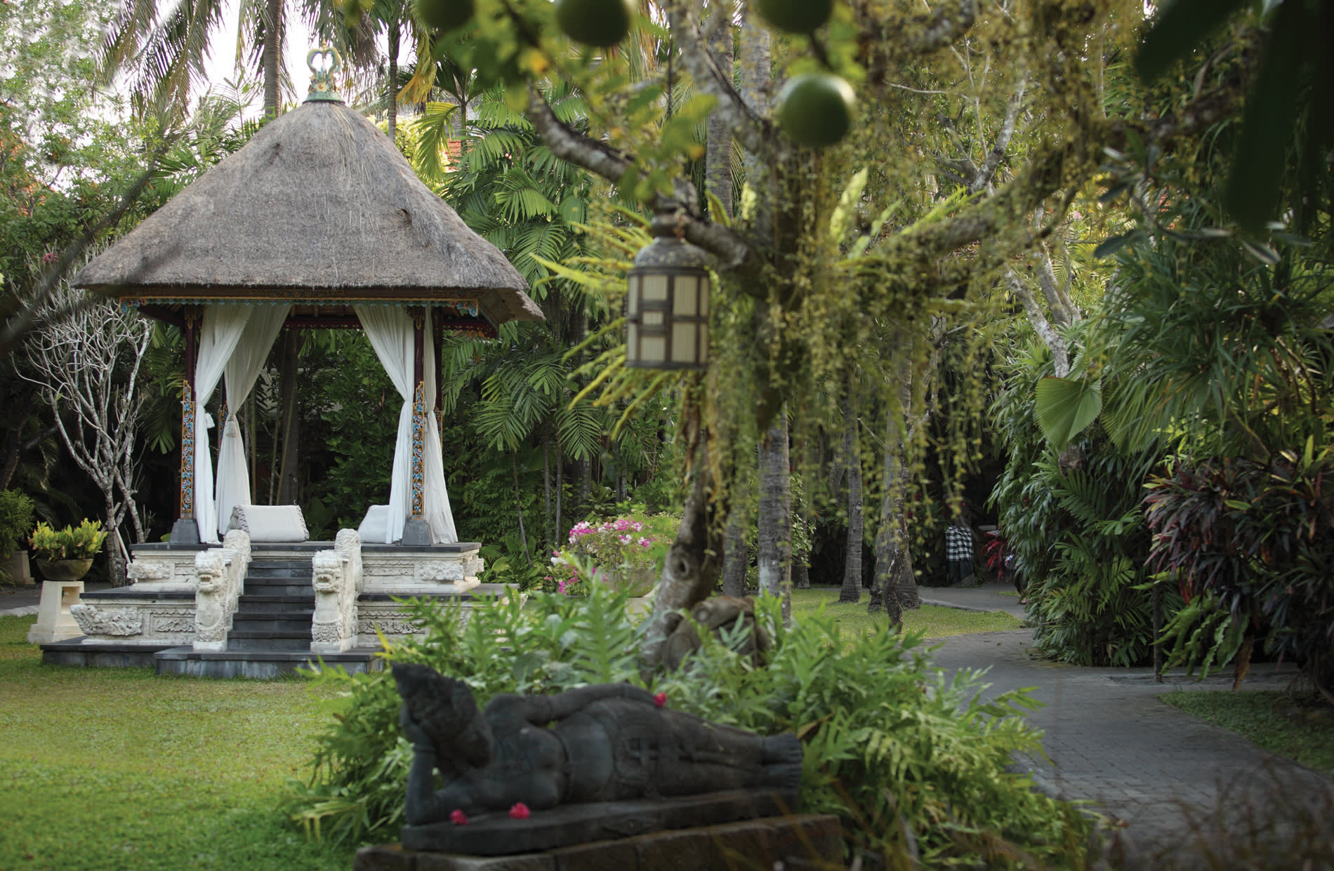 a wooden statue in a garden