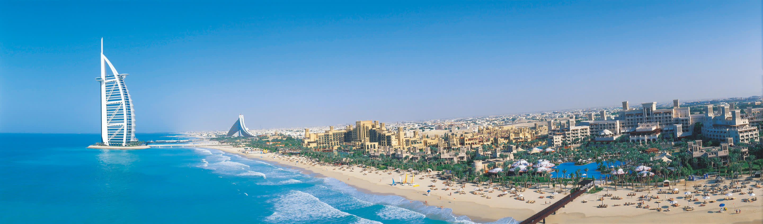 a group of people on a beach near a body of water