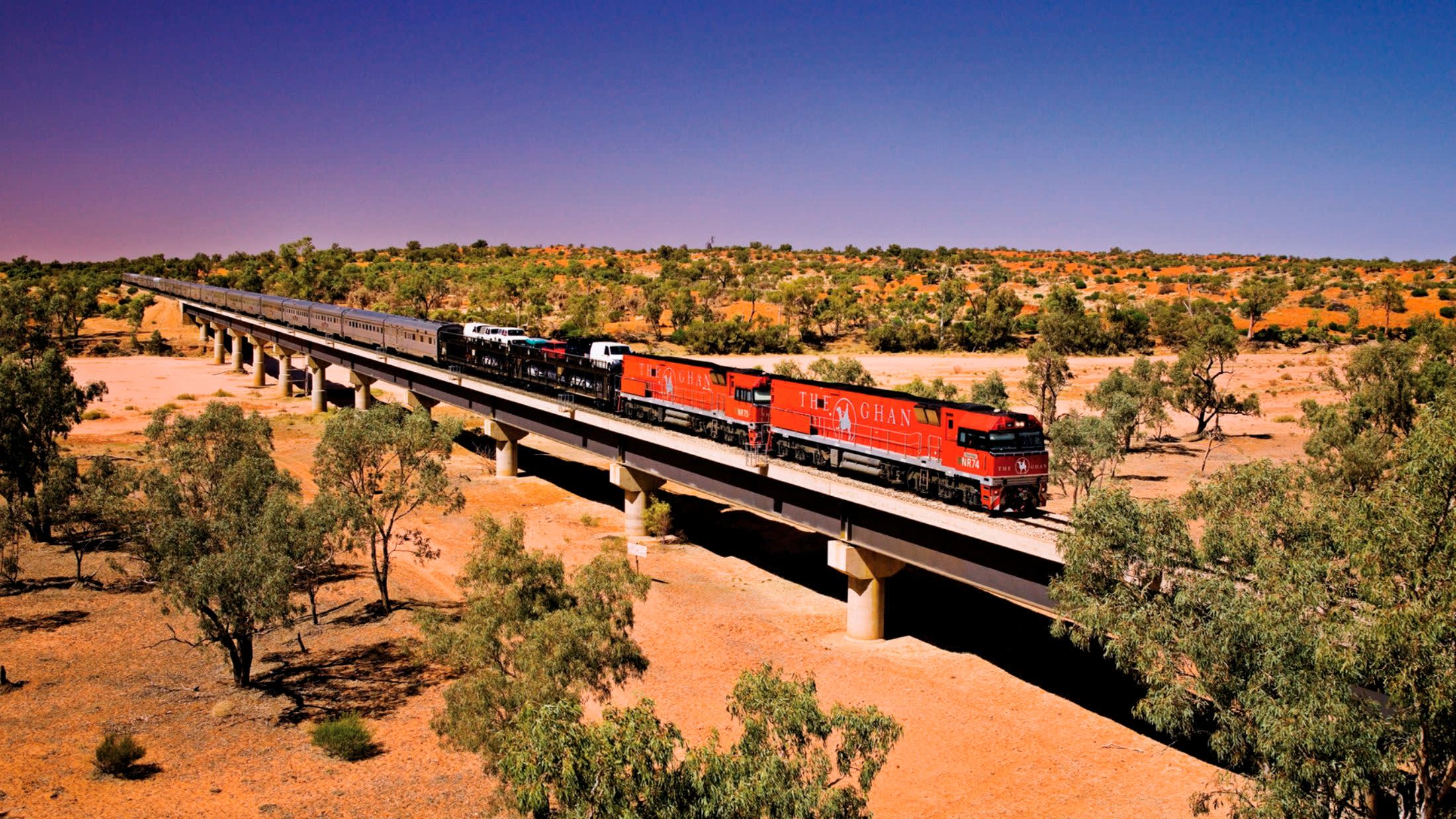 a train crossing a bridge over a river